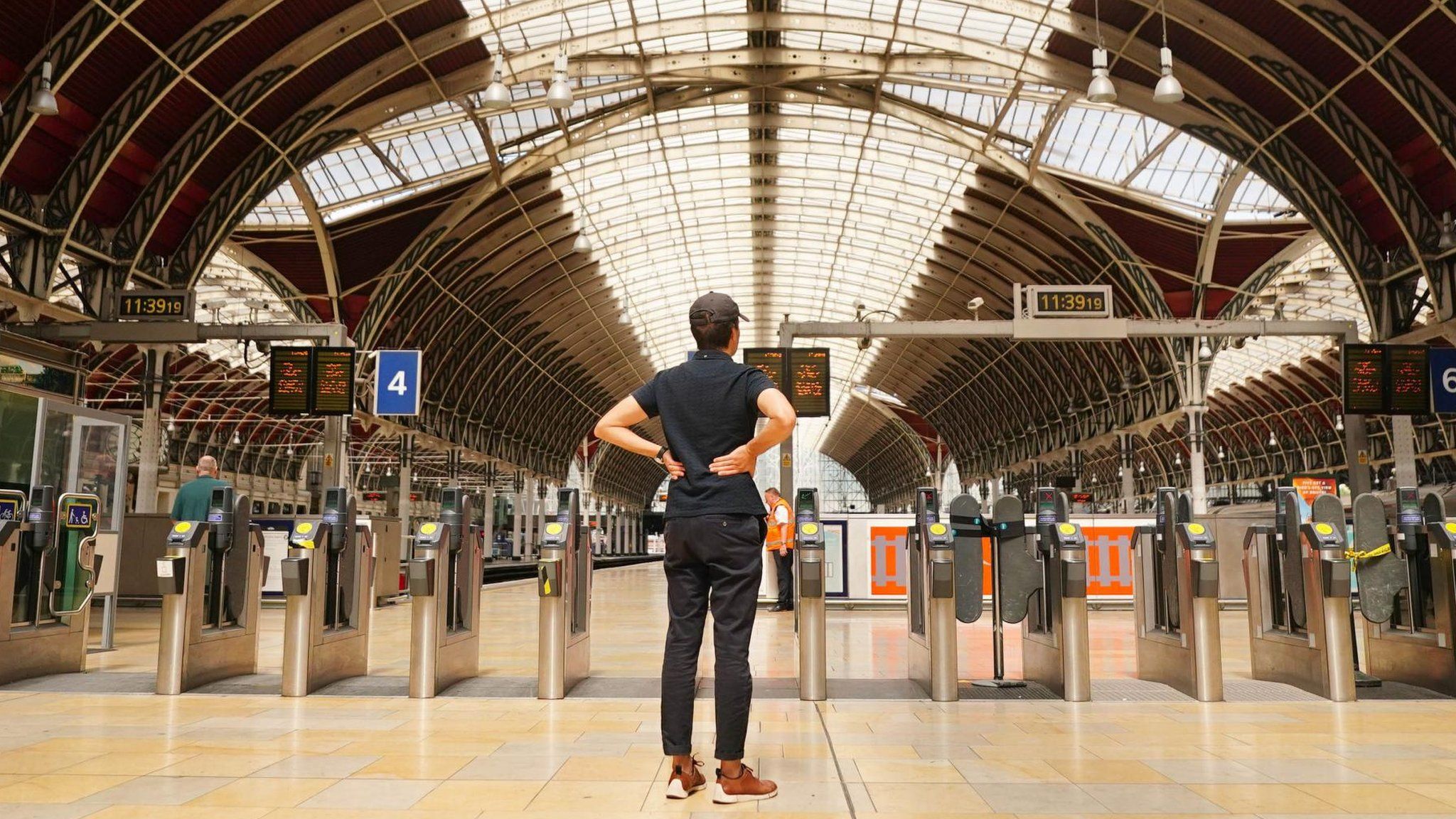 A man looks at boards showing cancellations last month