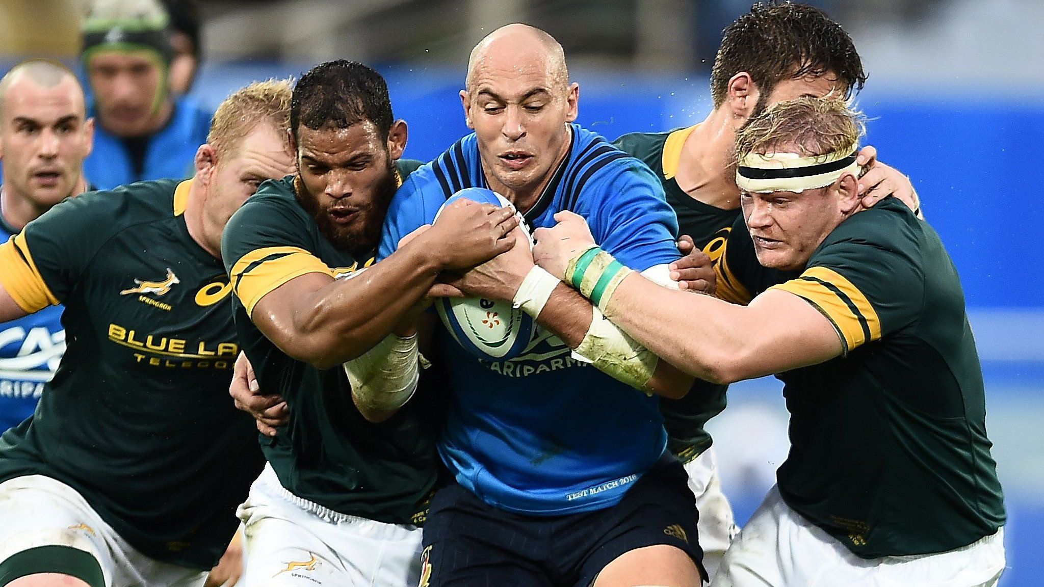 Italy's Sergio Parisse (centre) tackled by South Africa in Florence