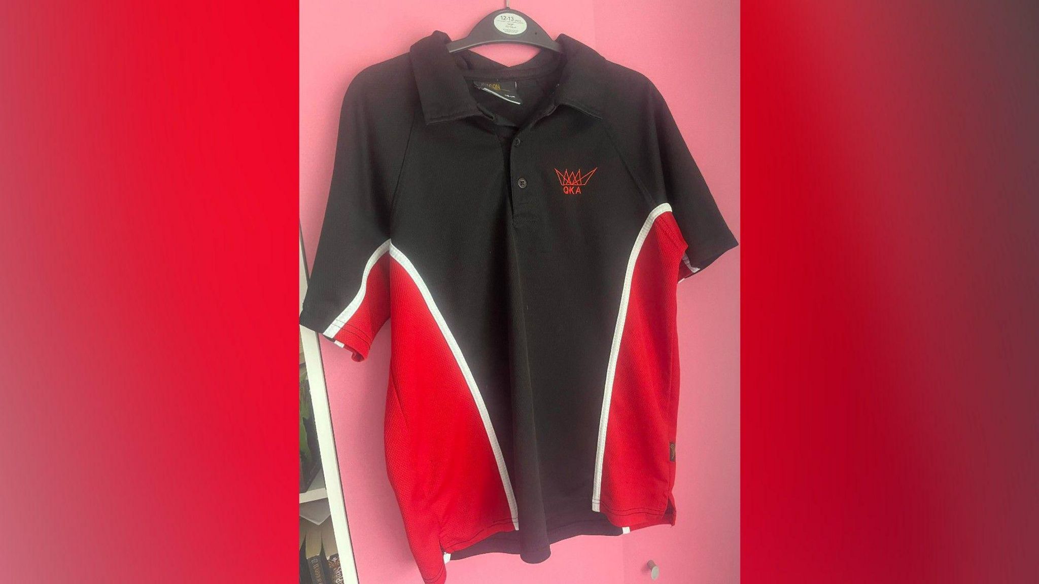 Red and black polo shirt on a hanger 