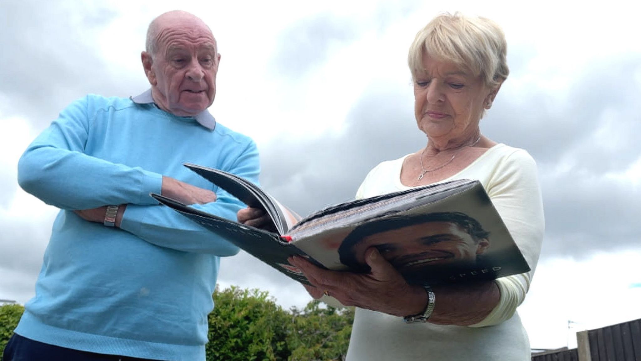 Roger and Carol Speed look at a book of pictures of their son Gary Speed