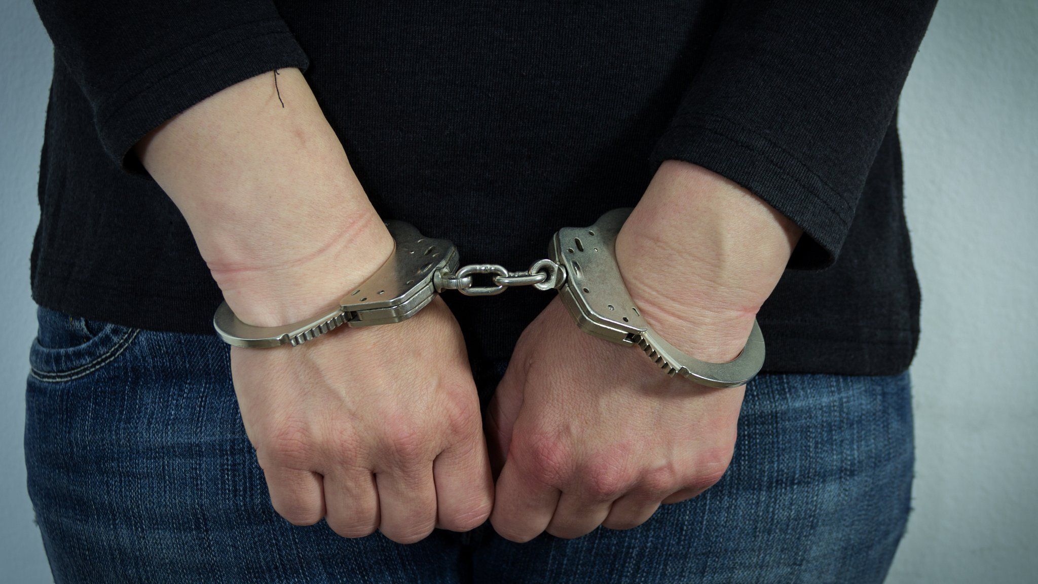 Generic photo of woman in handcuffs