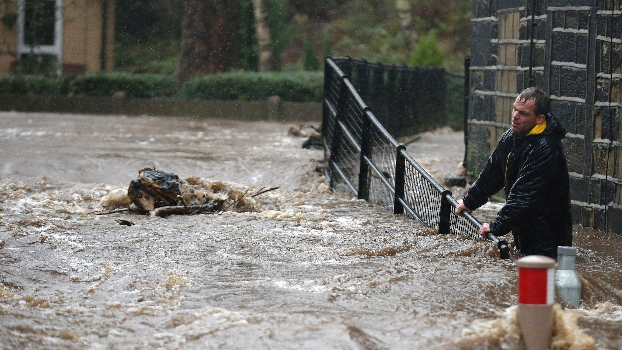 Residents battle against floodwater as the River Calder bursts its banks in the West Yorkshire town of Mytholmroyd on 26 December 2015