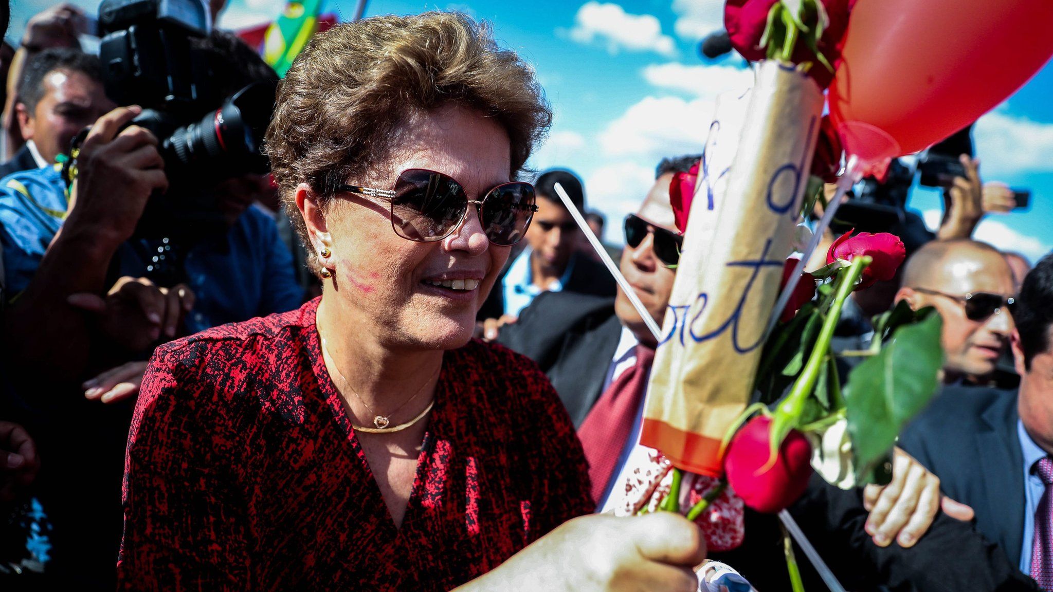 Dilma Rousseff receives flowers as she leaves Alvorada Palace in Brasilia. 6 Sept 2016