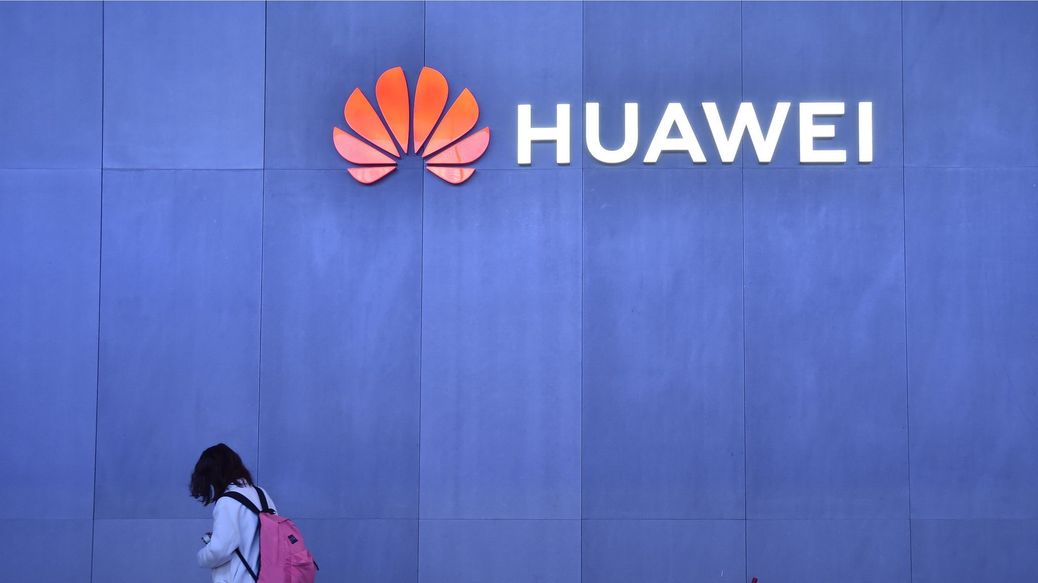An attendee walk by the Huawei booth at CES 2019 at the Las Vegas Convention Center on January 8, 2019 in Las Vegas, Nevada