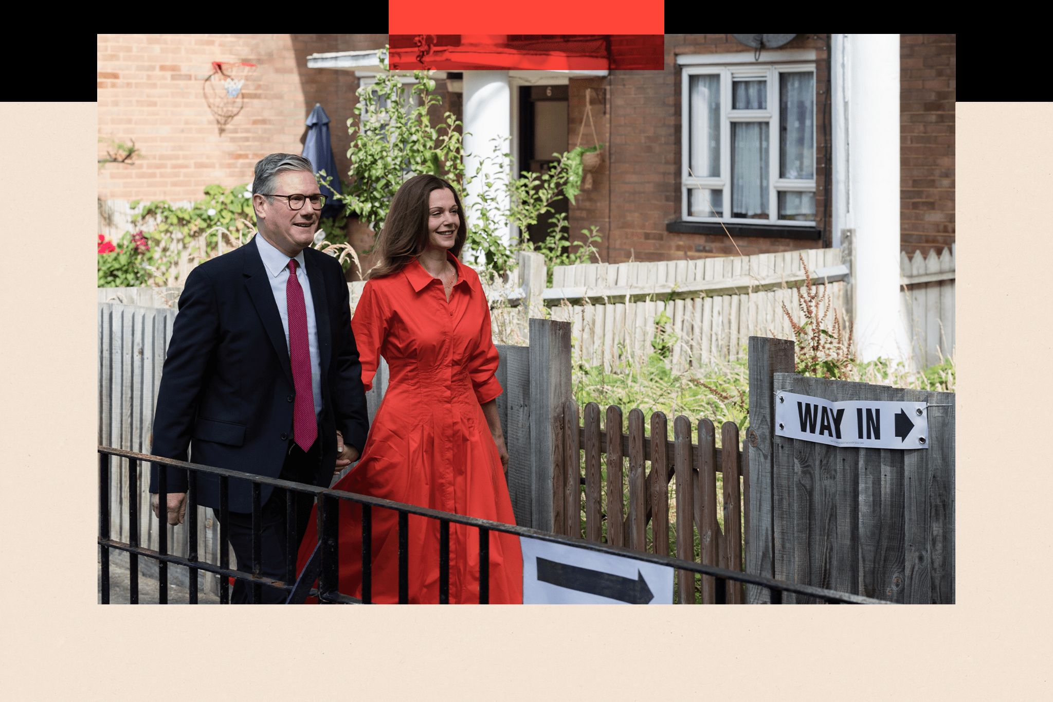  Sir Keir Starmer and his wife Victoria walk to a polling station to cast their votes. Ahead of them is a sign bearing the words "way in" and an arrow.