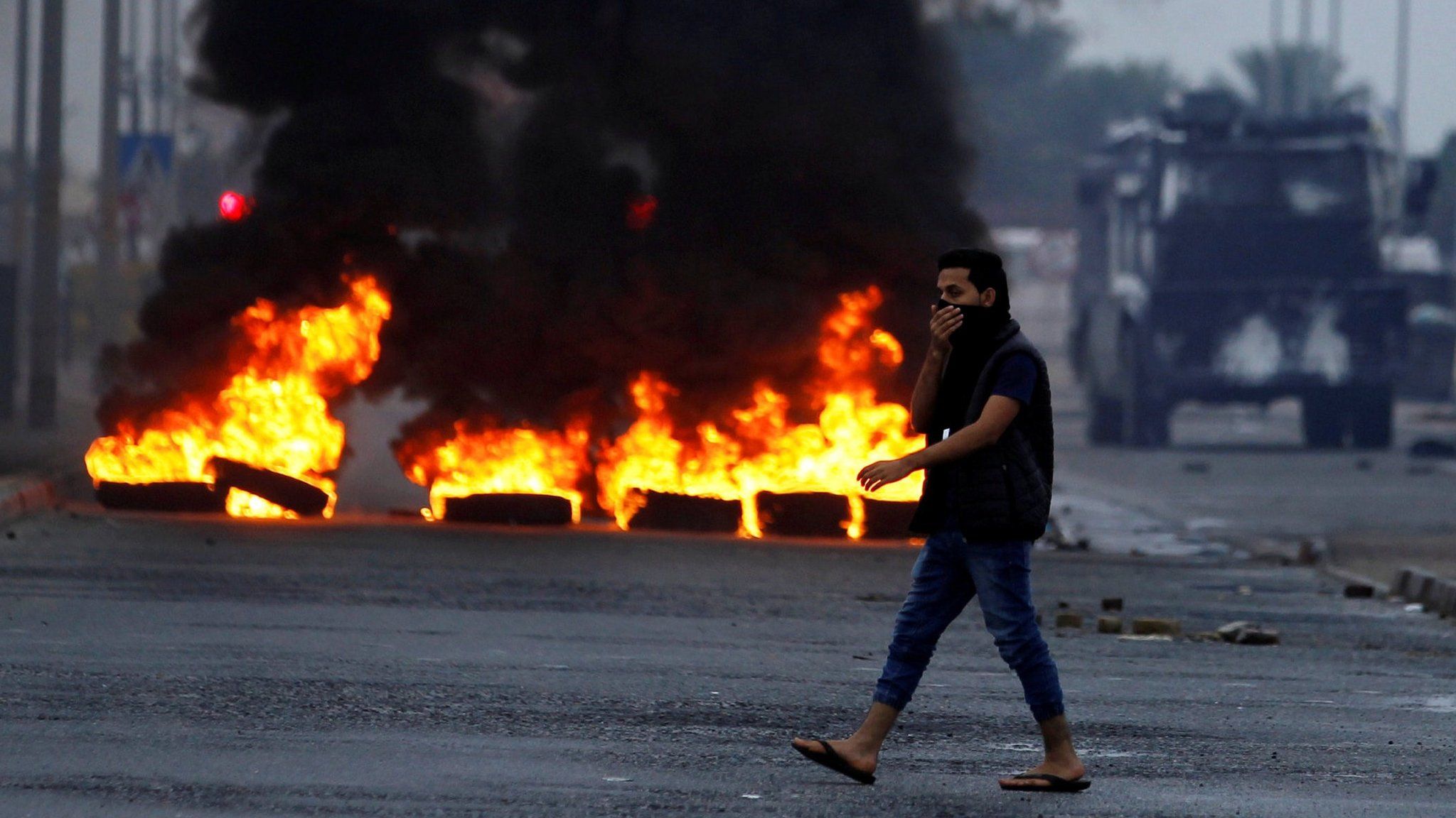 Anti-government protesters burn tyres and block a road during a protest to mark the 6th anniversary of the 14 February uprising in Bahrain, in the village of Sitra, south of Manama (14 February 2017)