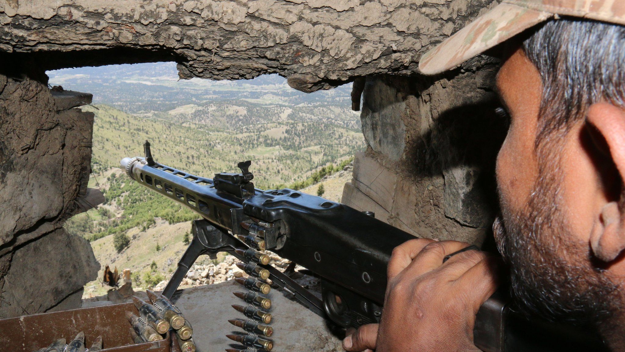 A Pakistani soldier keeps vigil from a post on top of a mountain in the former Taliban militants stronghold border area in Shawal valley on 20 May 2016