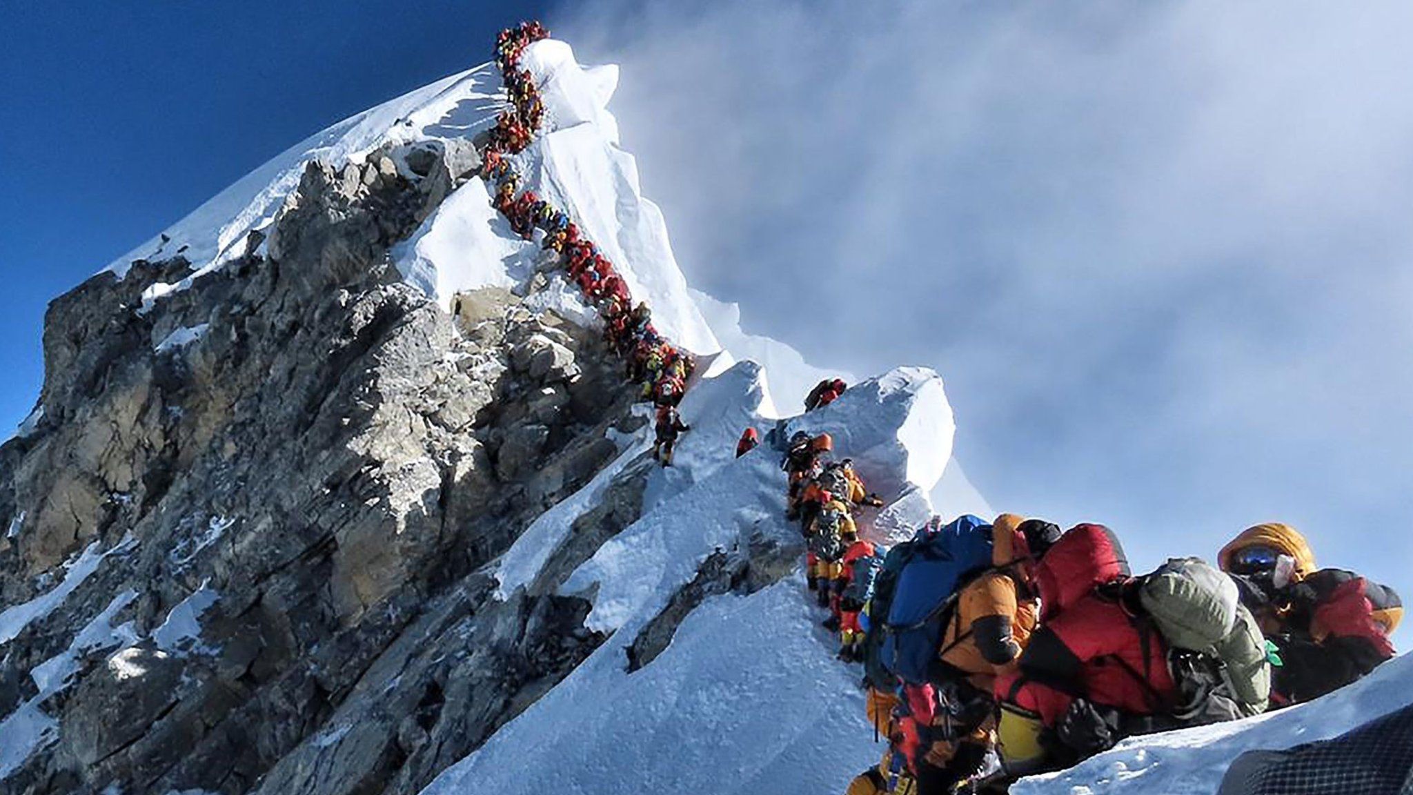 A photo from Nirmal Purja's Project Possible expedition shows a long queue of mountain climbers lining up to stand at the summit of Mount Everest