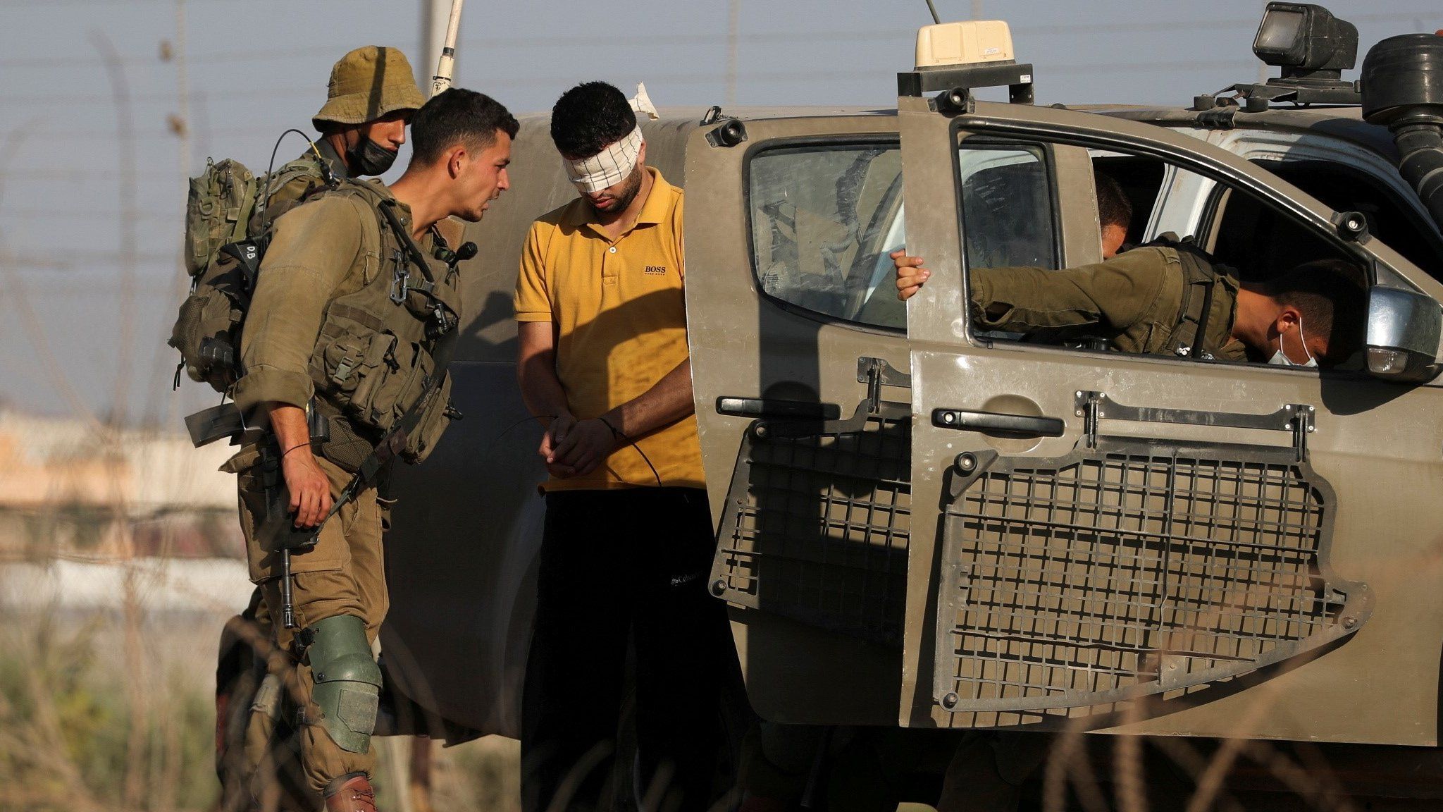 Israeli troops detain a man near the northern Israeli village of Muqeibla while searching for six Palestinian prisoners who escaped Gilboa jail (6 September 2021)