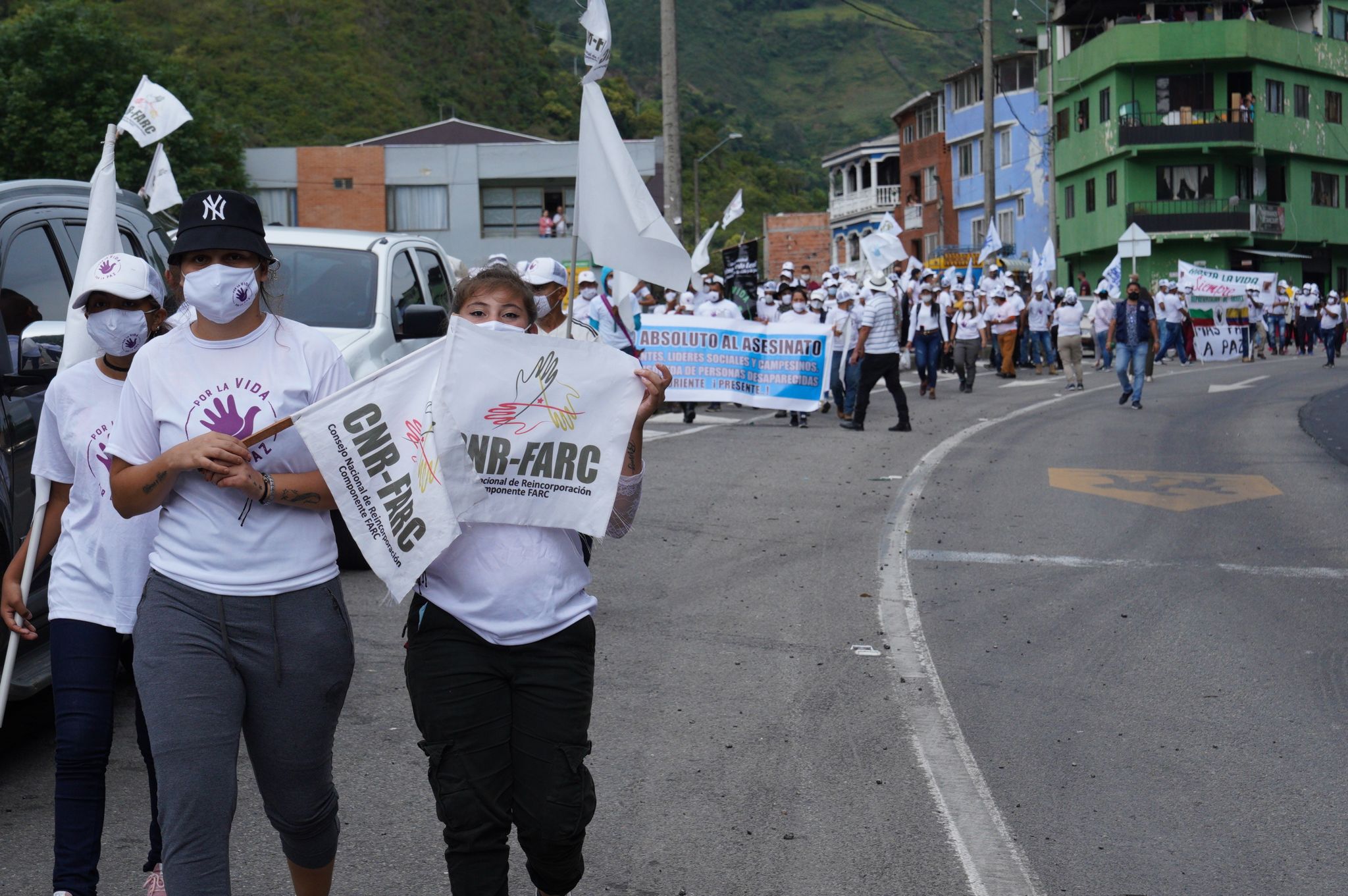 Former Farc fighters and their relatives march through the small town of Quetame on 31 October