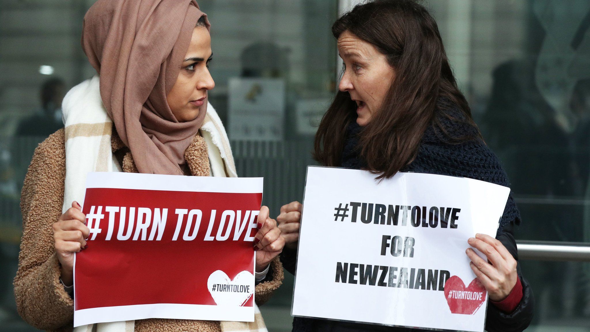 Members of the Turn to Love campaign hold placards outside New Zealand High Commission in Haymarket, London