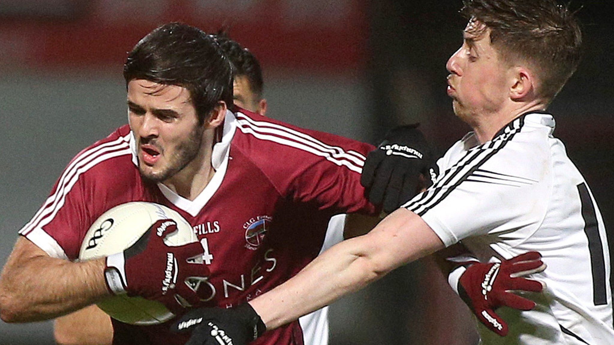 Slaughtneil defender Karl McKaigue is tackled by Omagh's Conan McGrugan