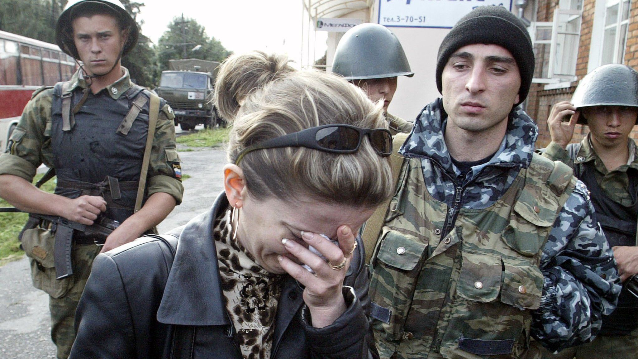 A woman cries in front of soldiers cordoning off the school building in the town of Beslan, North Ossetia, 04 September 2004