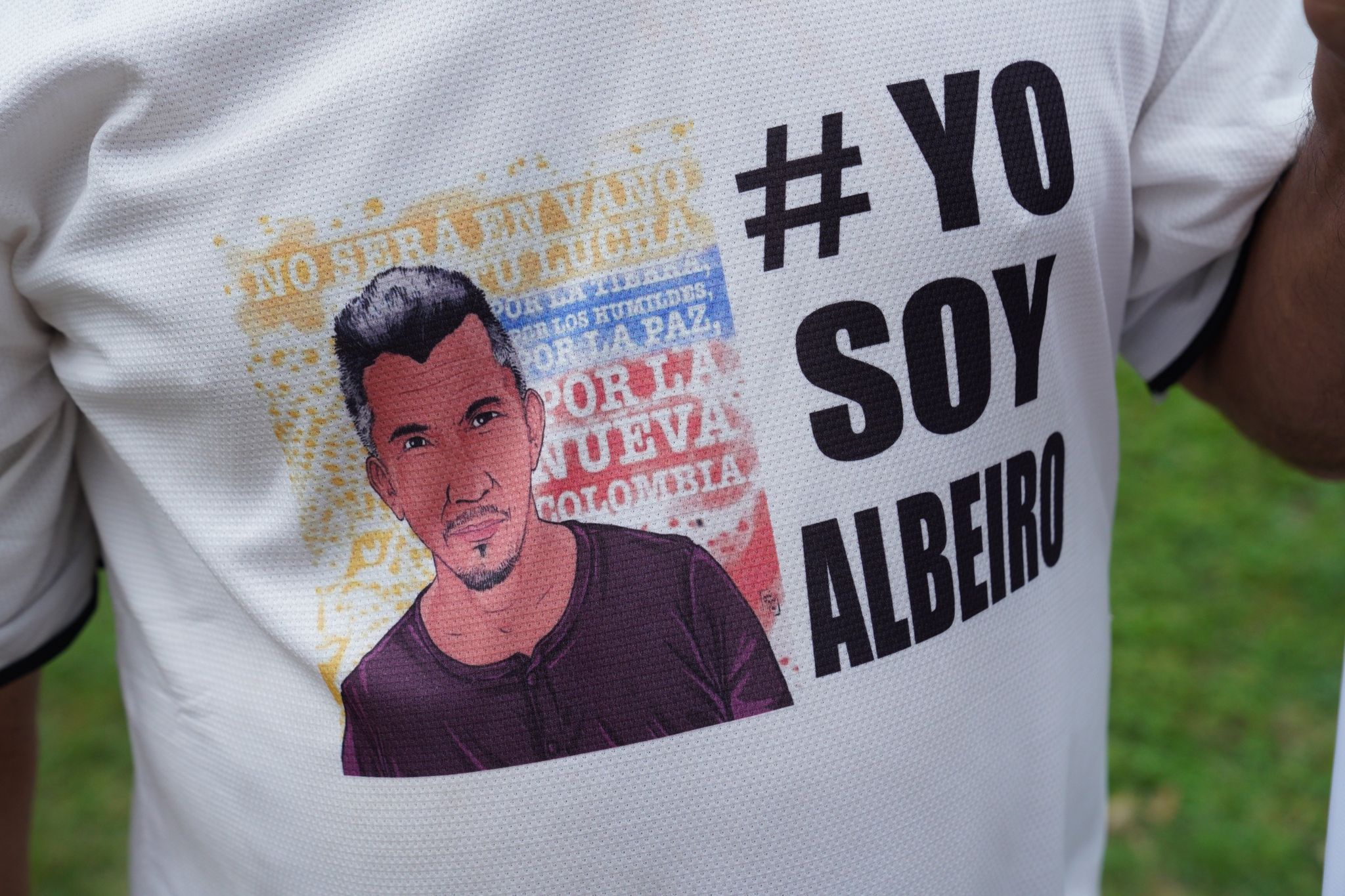 A former FARC fighter wears a t-shirt with the image of Juan de Jesus Monroy, also known as Albeiro, a FARC party leader murdered in October. The assassination unleashed Sunday's march on Bogota.