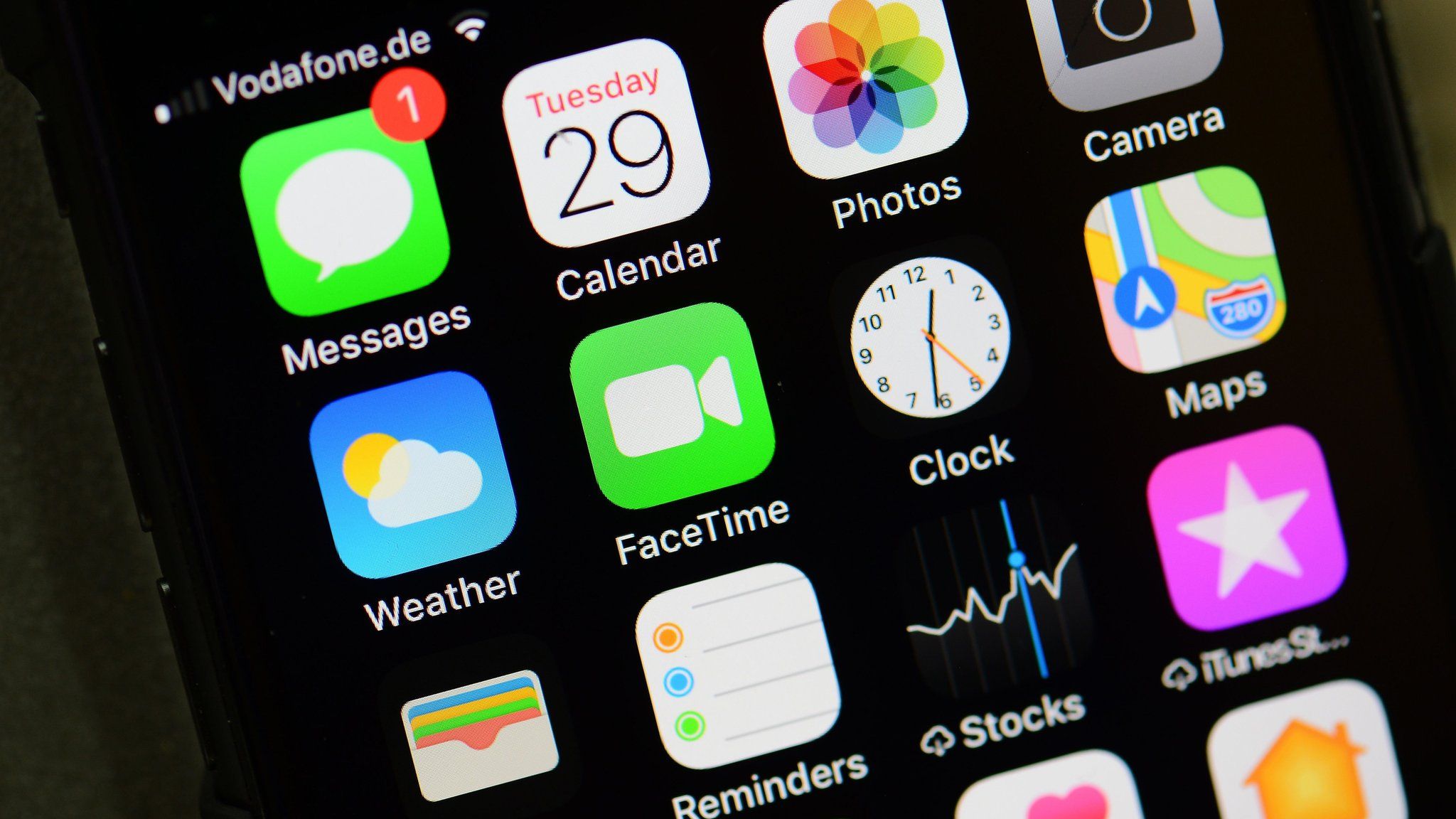 An iPhone home screen is pictured showing its many apps