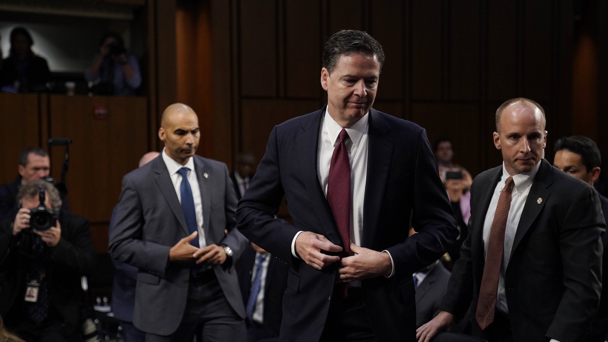 James Comey gets up to leave after giving testimony to the Senate Intelligence Committee