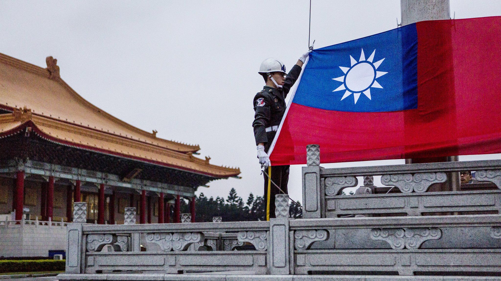 Guards prepare to raise the Taiwan flag in the Chiang Kai-shek Memorial Hall square ahead of the Taiwanese presidential election in Taipei, Taiwan, 14 January 2016
