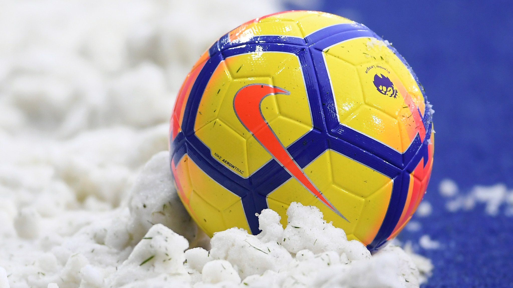 A Premier League ball surrounded by snow during the winter