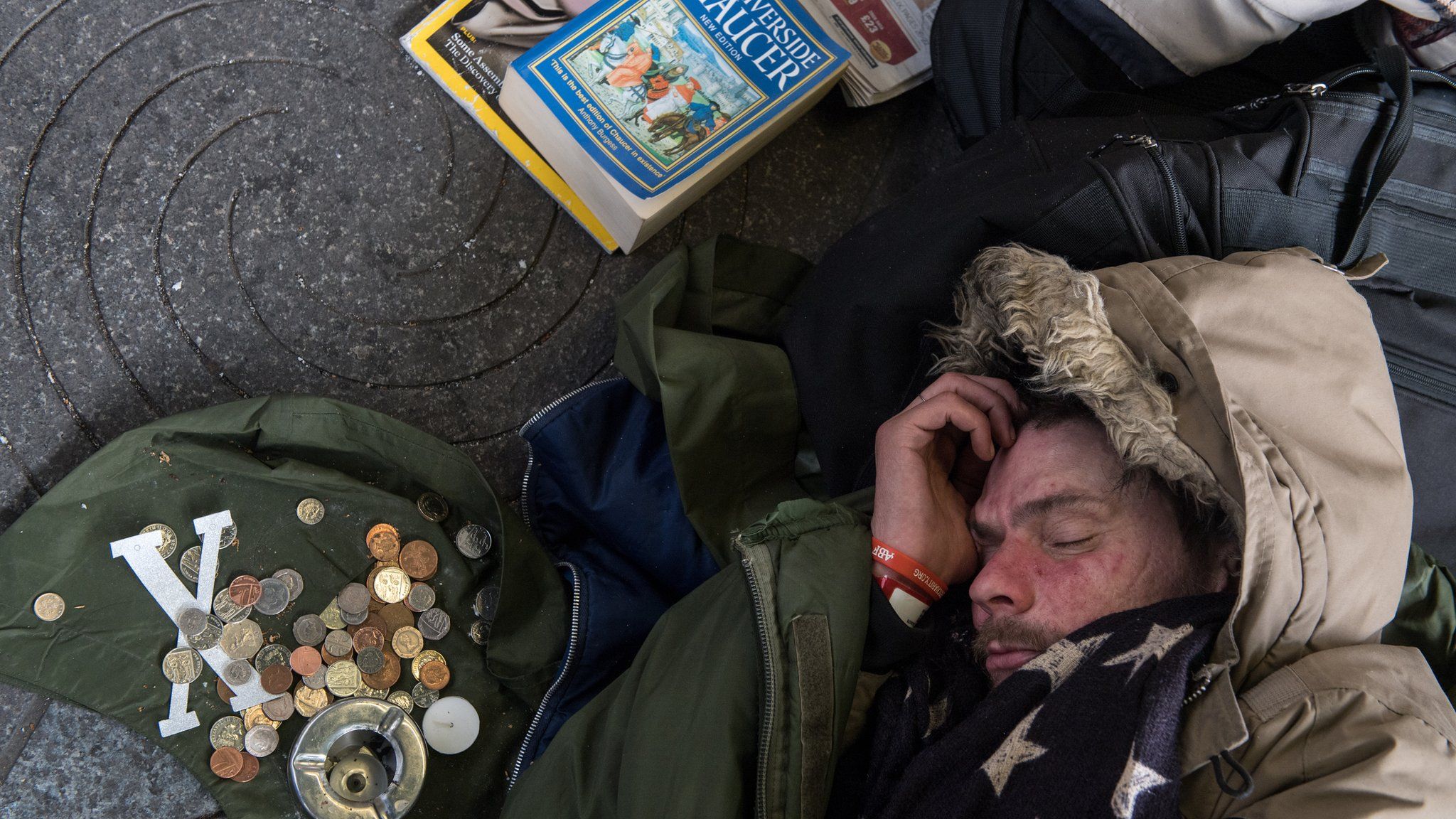 Homeless man sleeping by donations