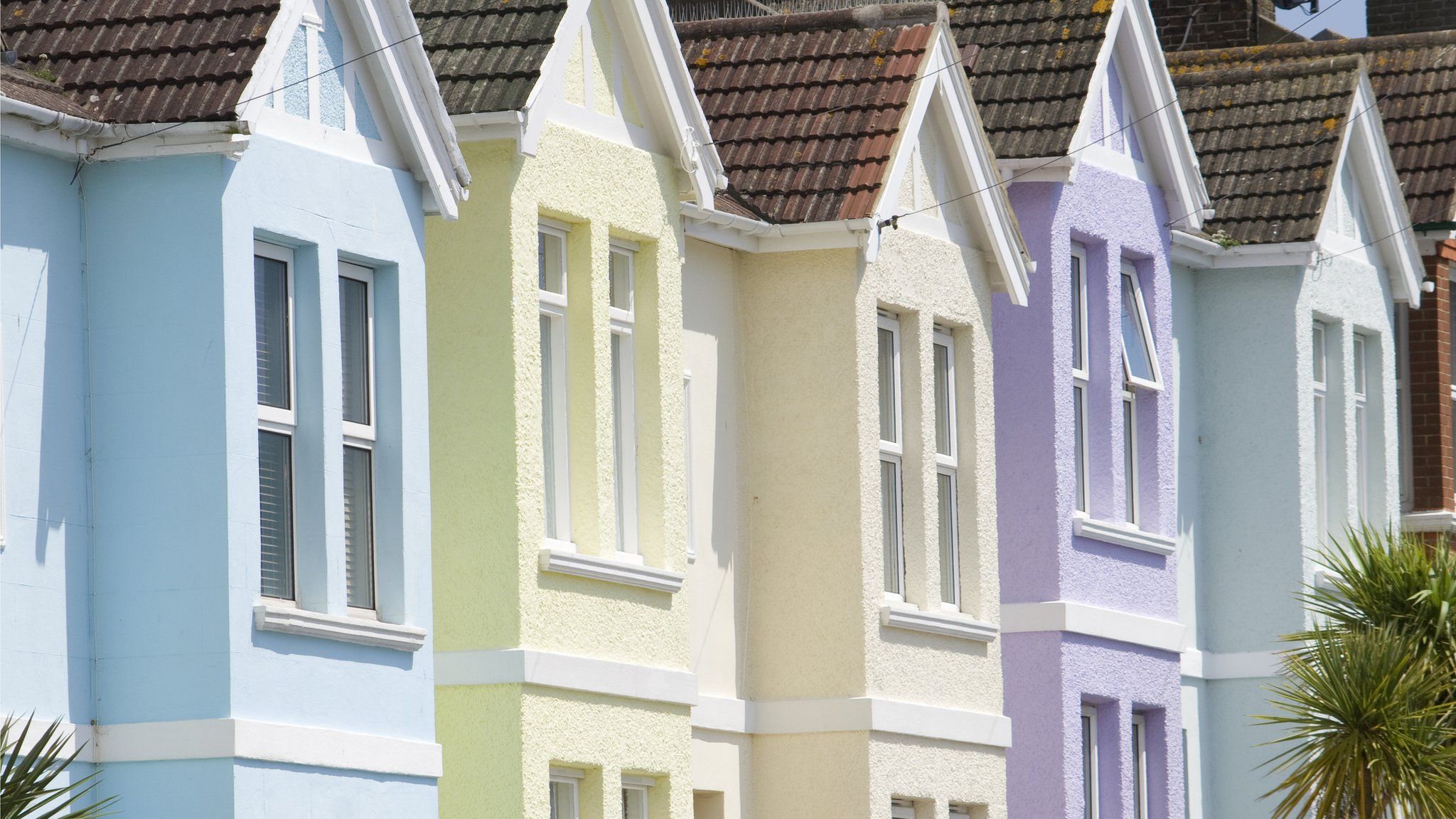 A close up of five pastel painted homes in Brighton