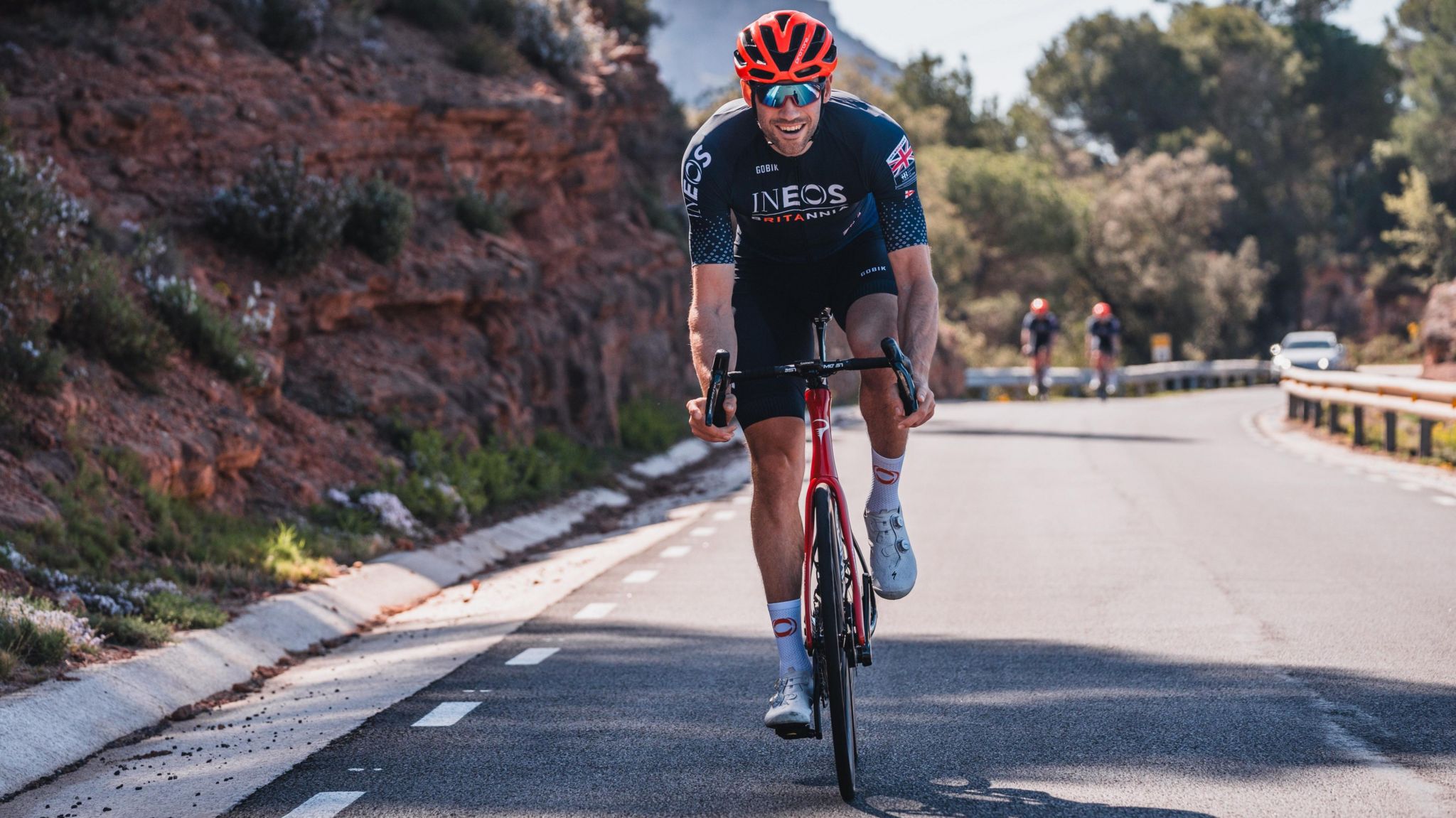 An Ineos Britannia cyclor on a training ride on a sunny day in the mountains