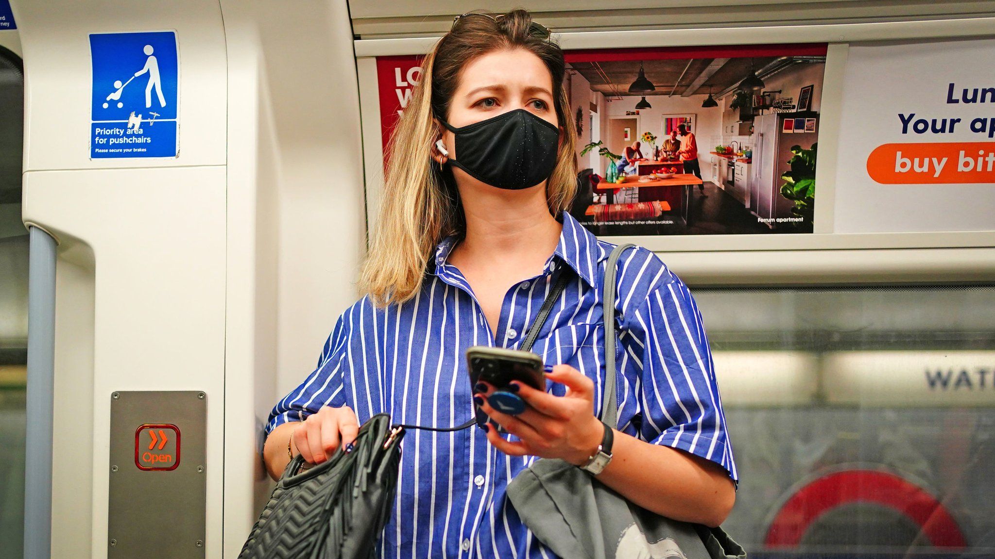 Woman wearing a mask on the tube