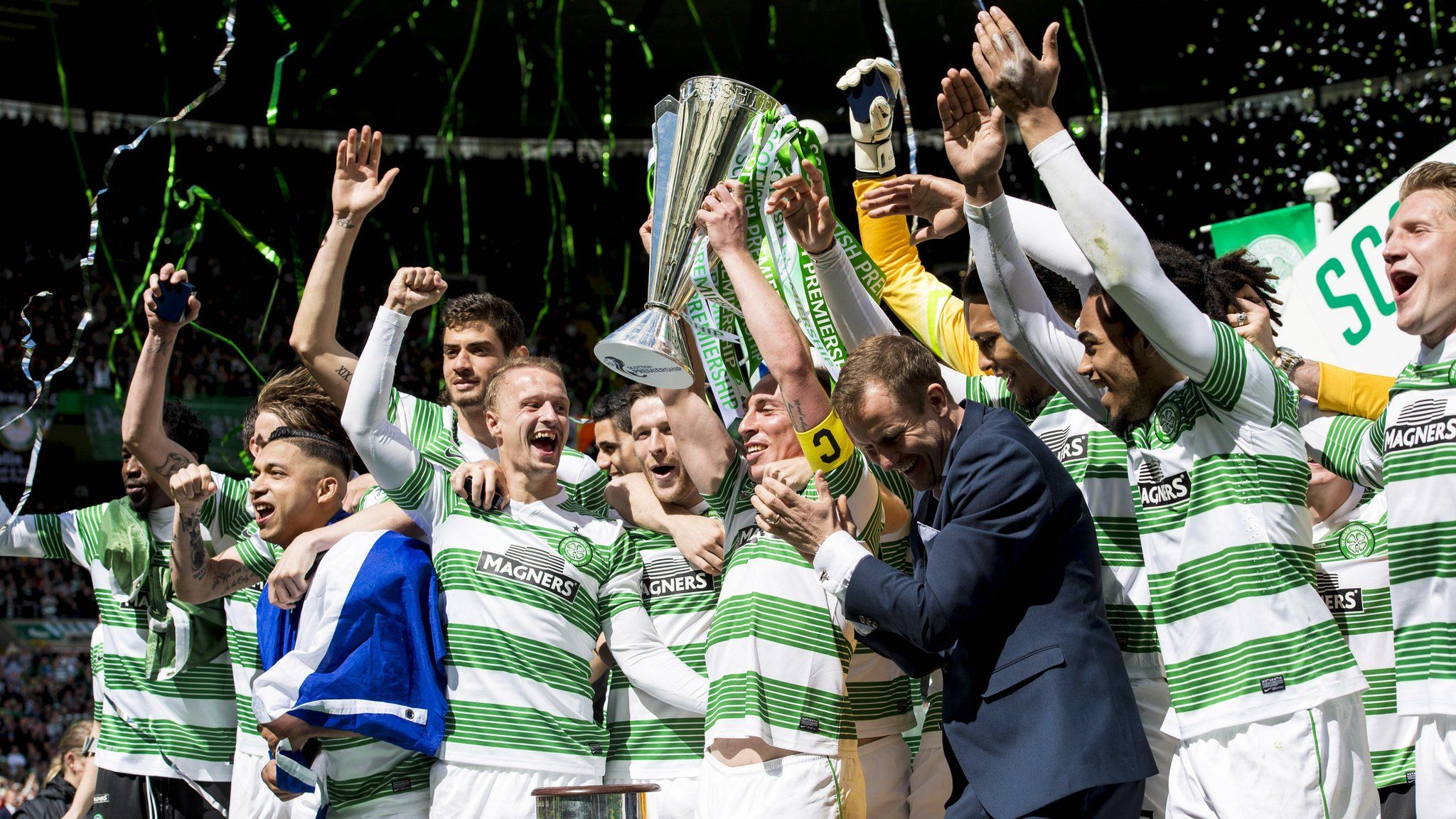 Celtic players celebrating with the Scottish Premirship trophy