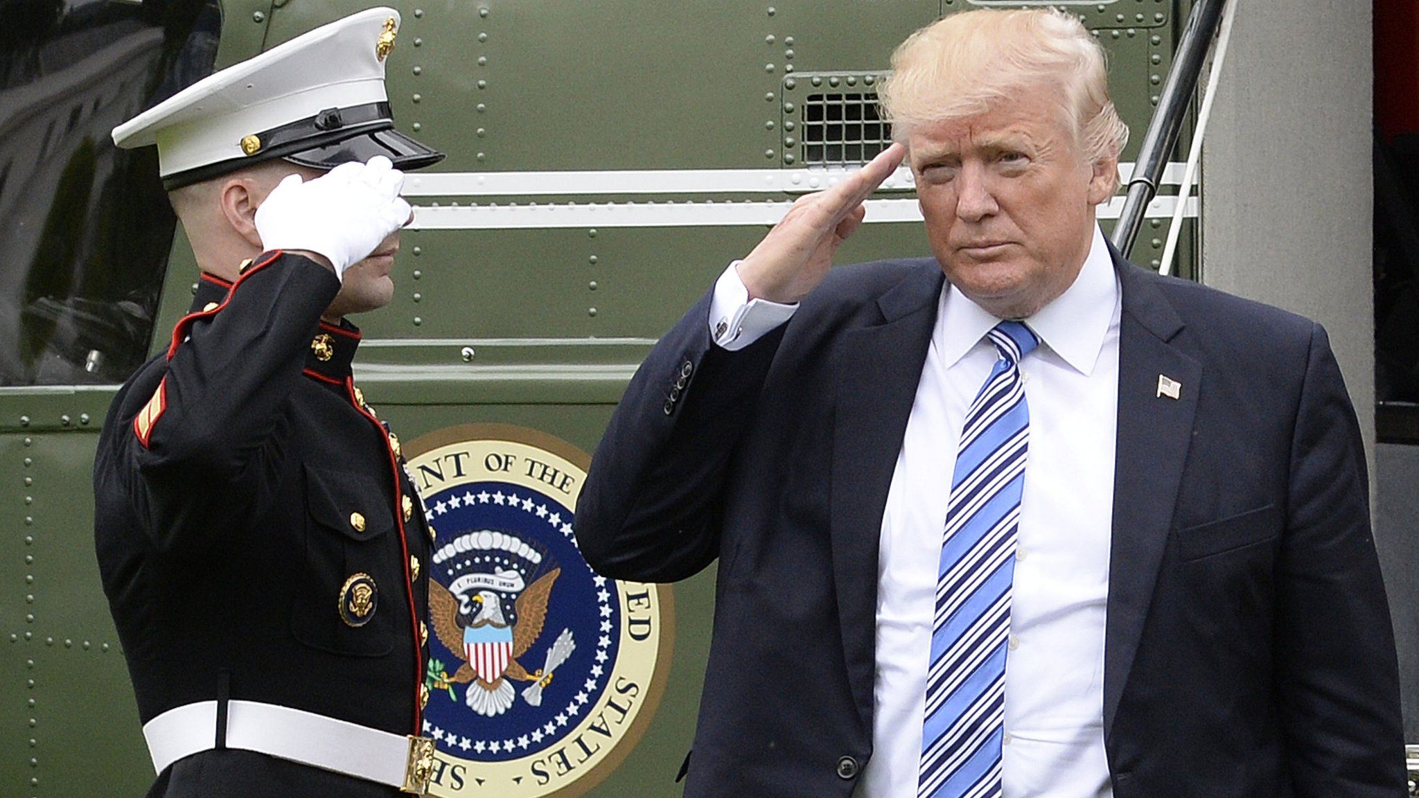 Donald Trump salutes the Marine Guard as he disembarks from Marine One at the White House. 13 May 2017