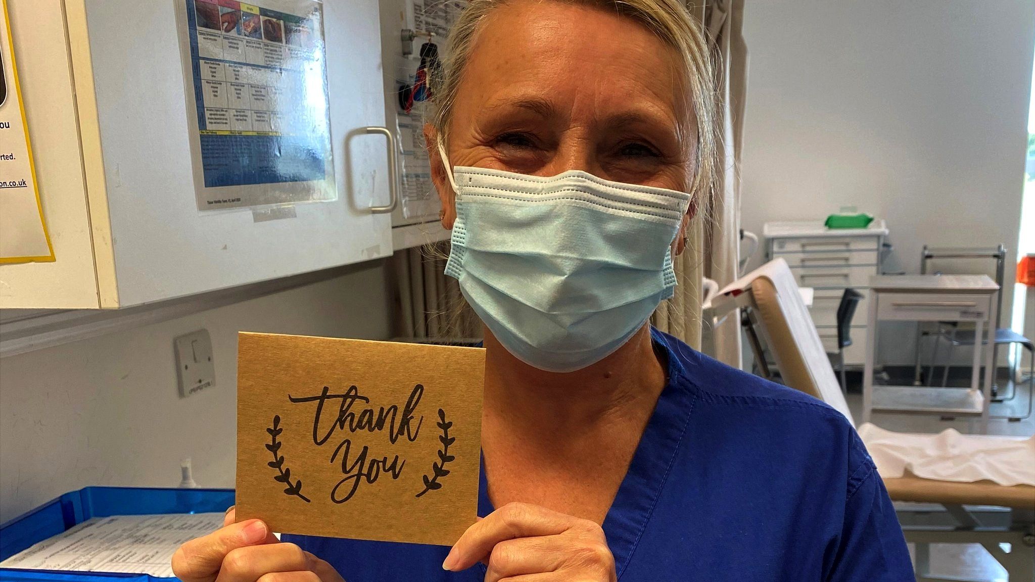 Nurse holding Thank You card