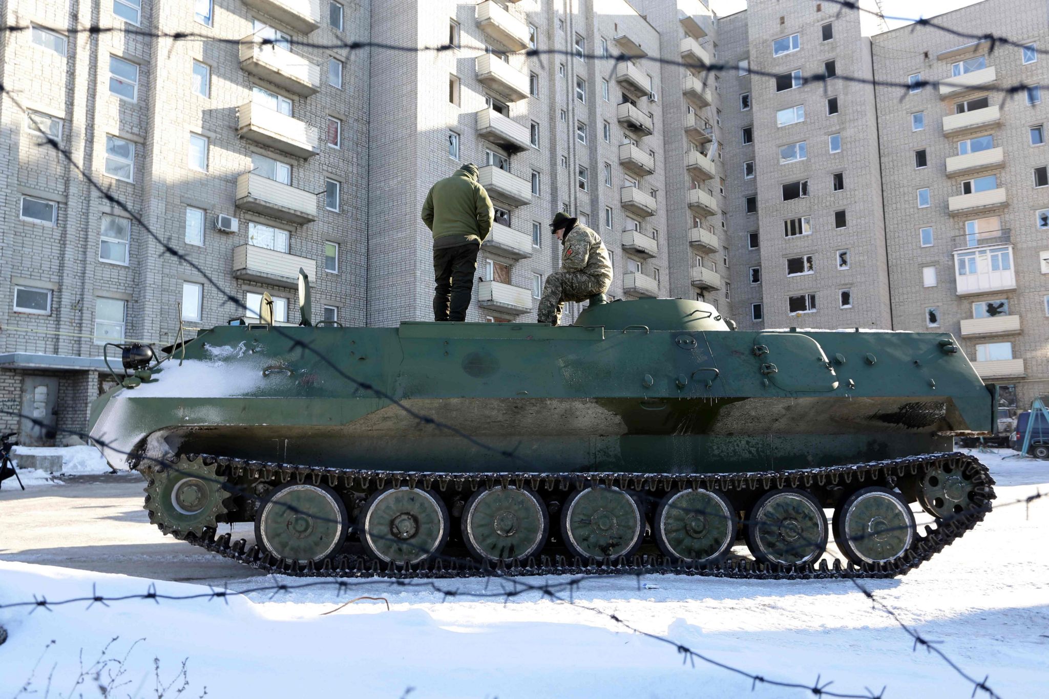 Ukrainian medical servicemen stand on at tank in Avdiivka in January 2017