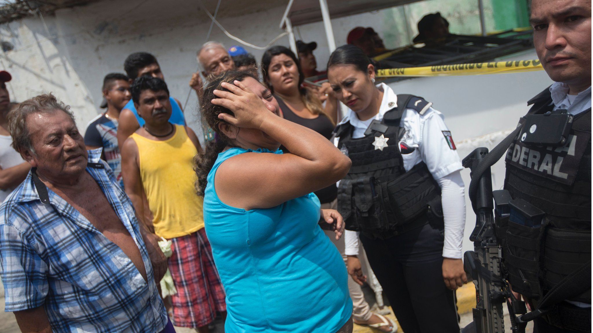Relatives of five people murdered on a street cry in Acapulco's Icacos neighborhood, Guerrero State, Mexico, on April 17, 2016.