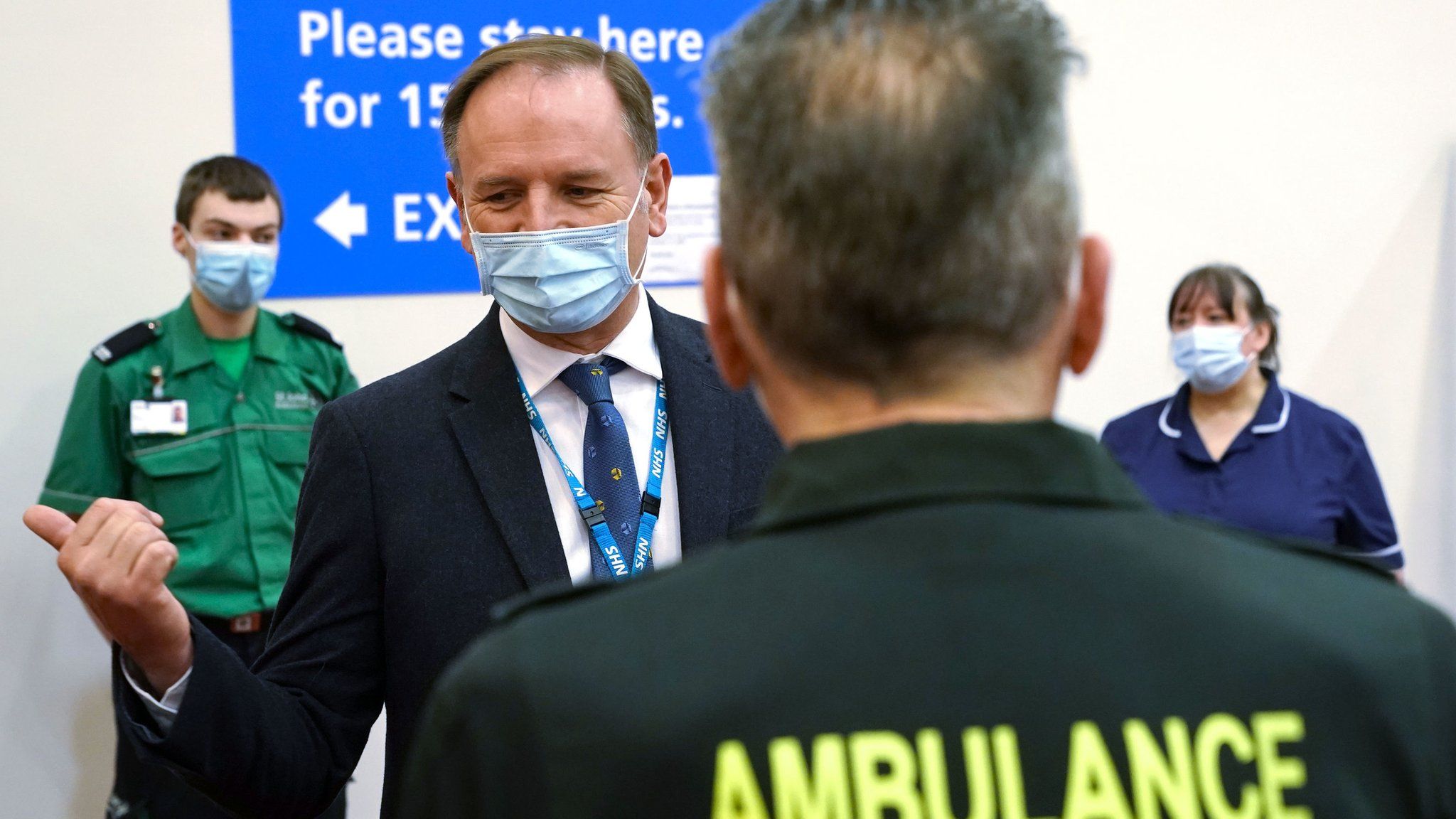 Sir Simon Stevens talks to a member of the vaccine team during a visit to the Centre for Life in Newcastle