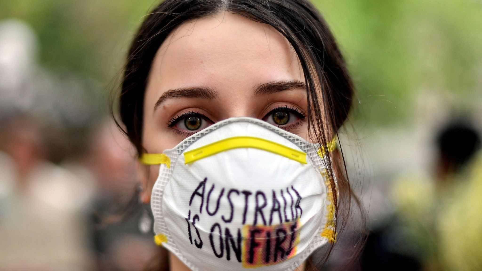 A demonstrator wearing a mask attends a climate protest rally in Sydney on December 11, 2019.