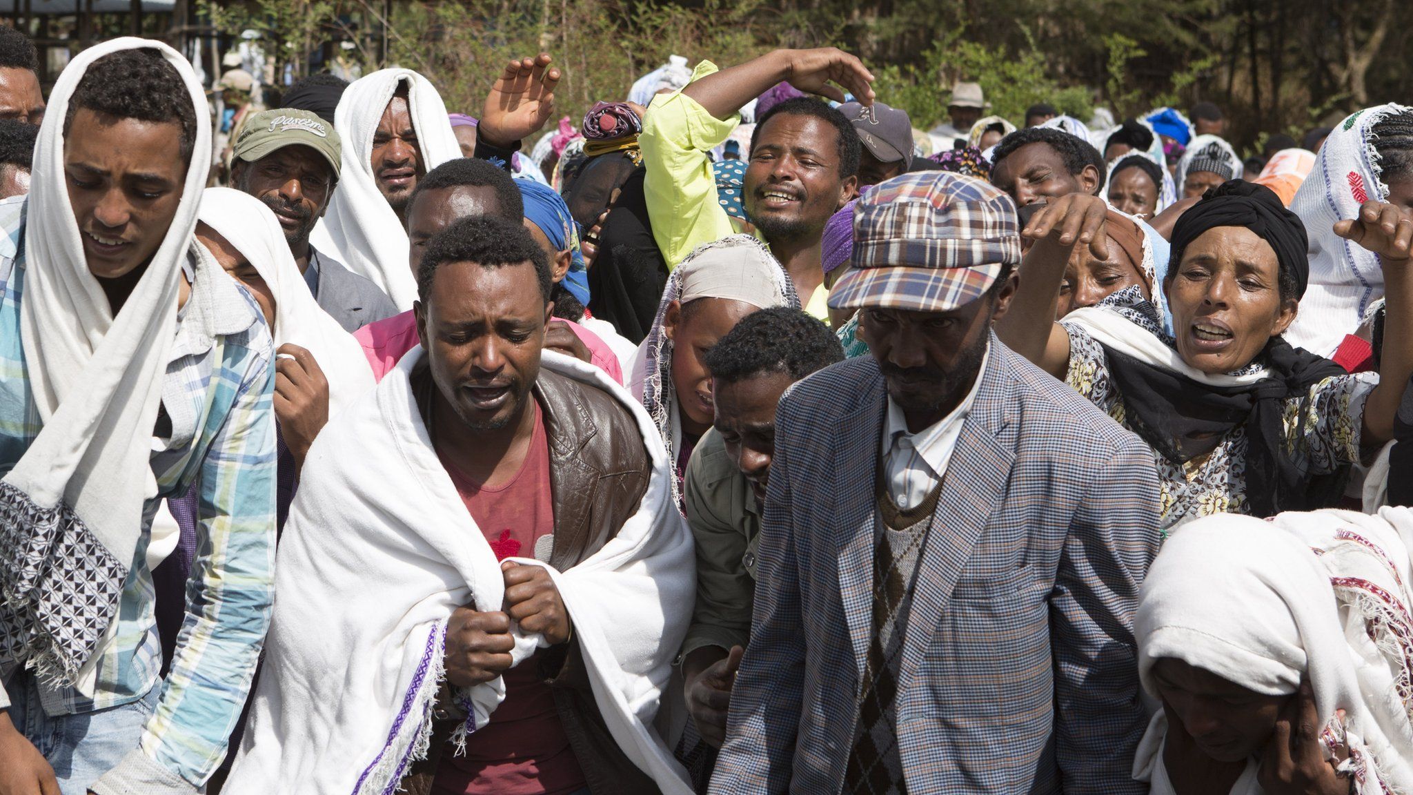 People mourn the death a man who was shot dead by the Ethiopian forces the day earlier, in the Yubdo Village, about 100km from Addis Ababa in the Oromia region, on 17 December 2015