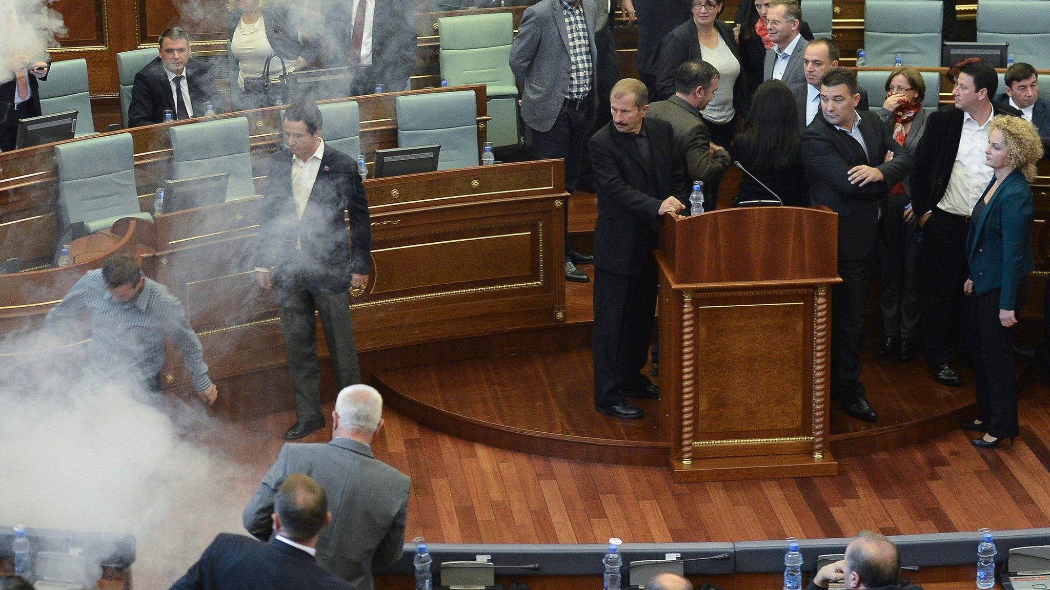Opposition lawmakers throw tear gas during a session of Kosovo's parliament in Pristina, Kosovo (15 October 2015)