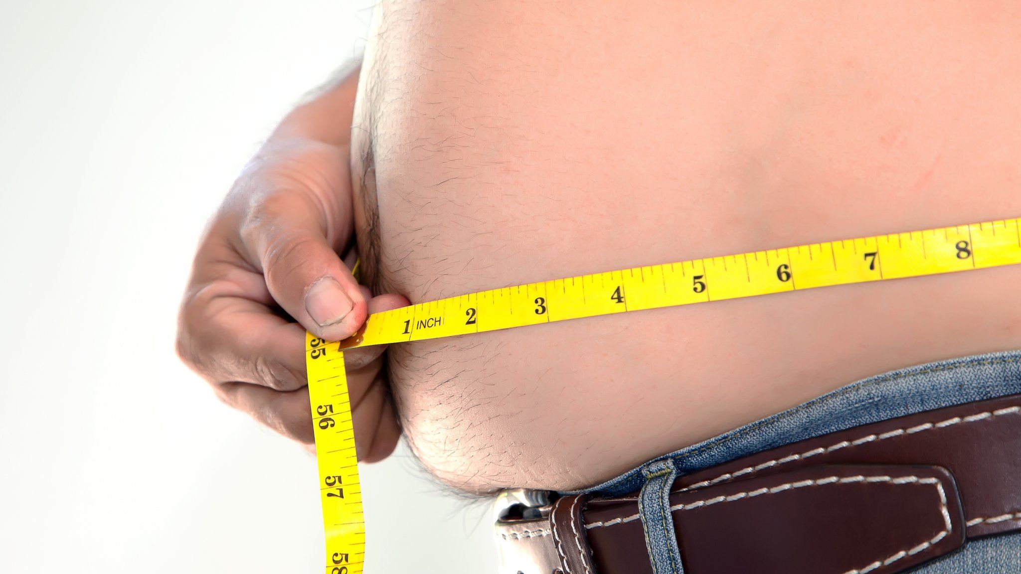 Man measuring waistline