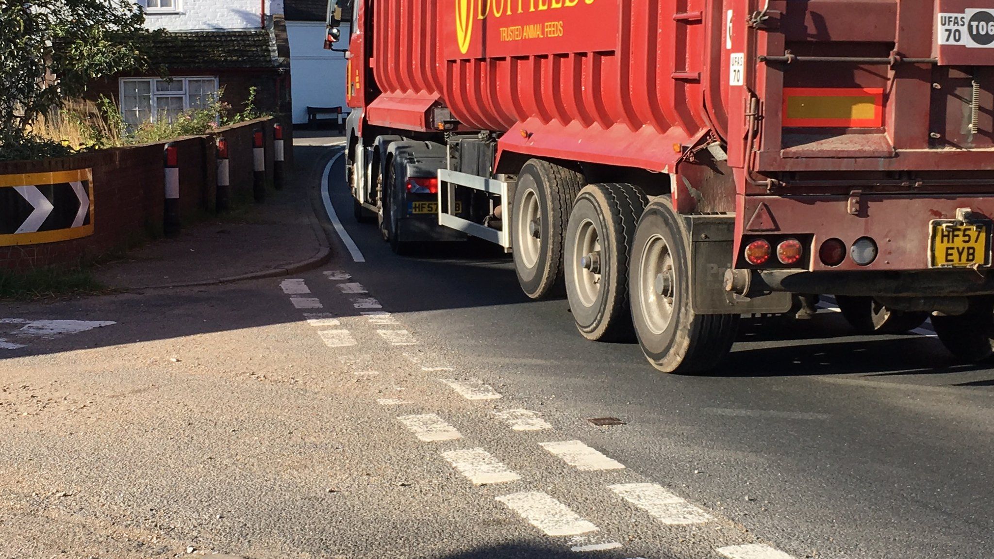 HGV lorry driving through village on single carriageway of A12