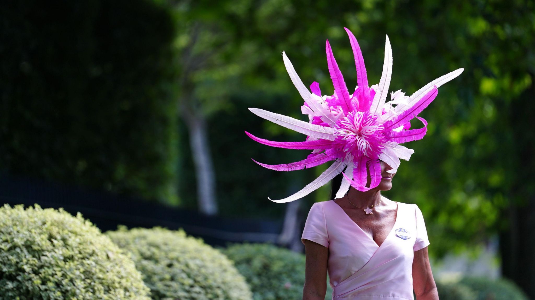 Milliner Ilda Di Vico wears a pink and white feather headdress