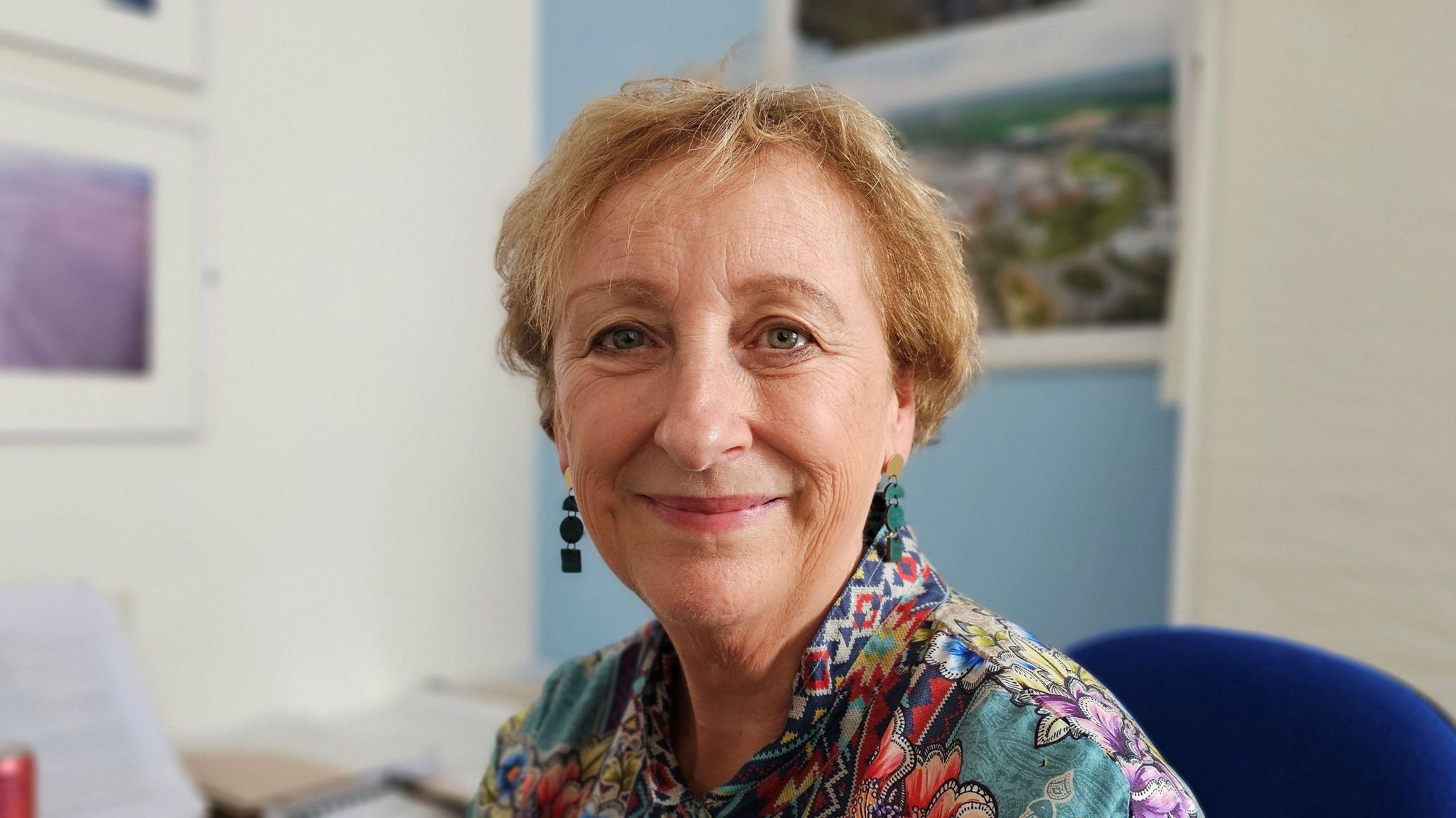 Prof Lesley Dwyer sitting in her office and smiling