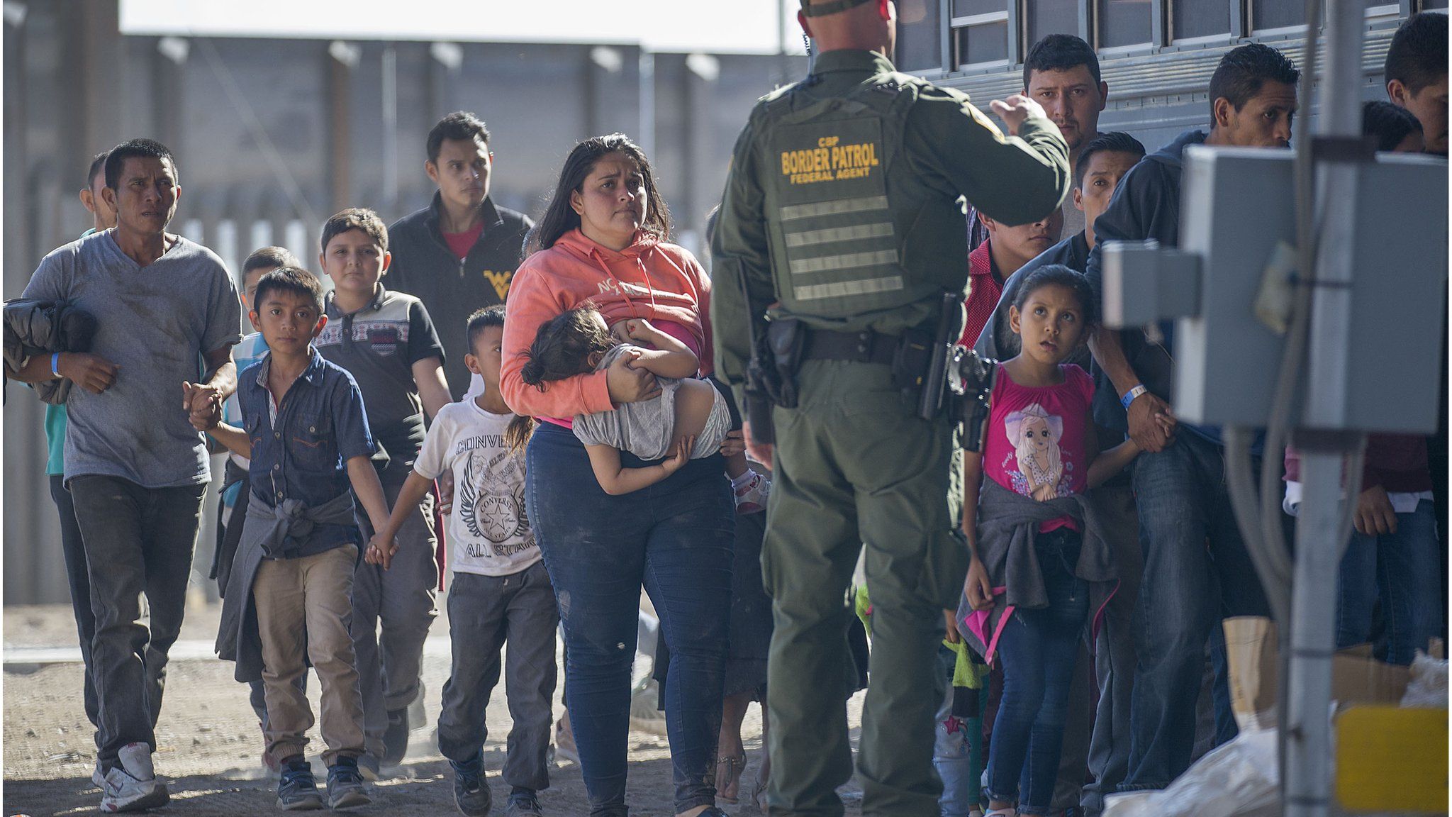 Migrants are loaded on to a bus in El Paso, Texas, on 1 June 2019