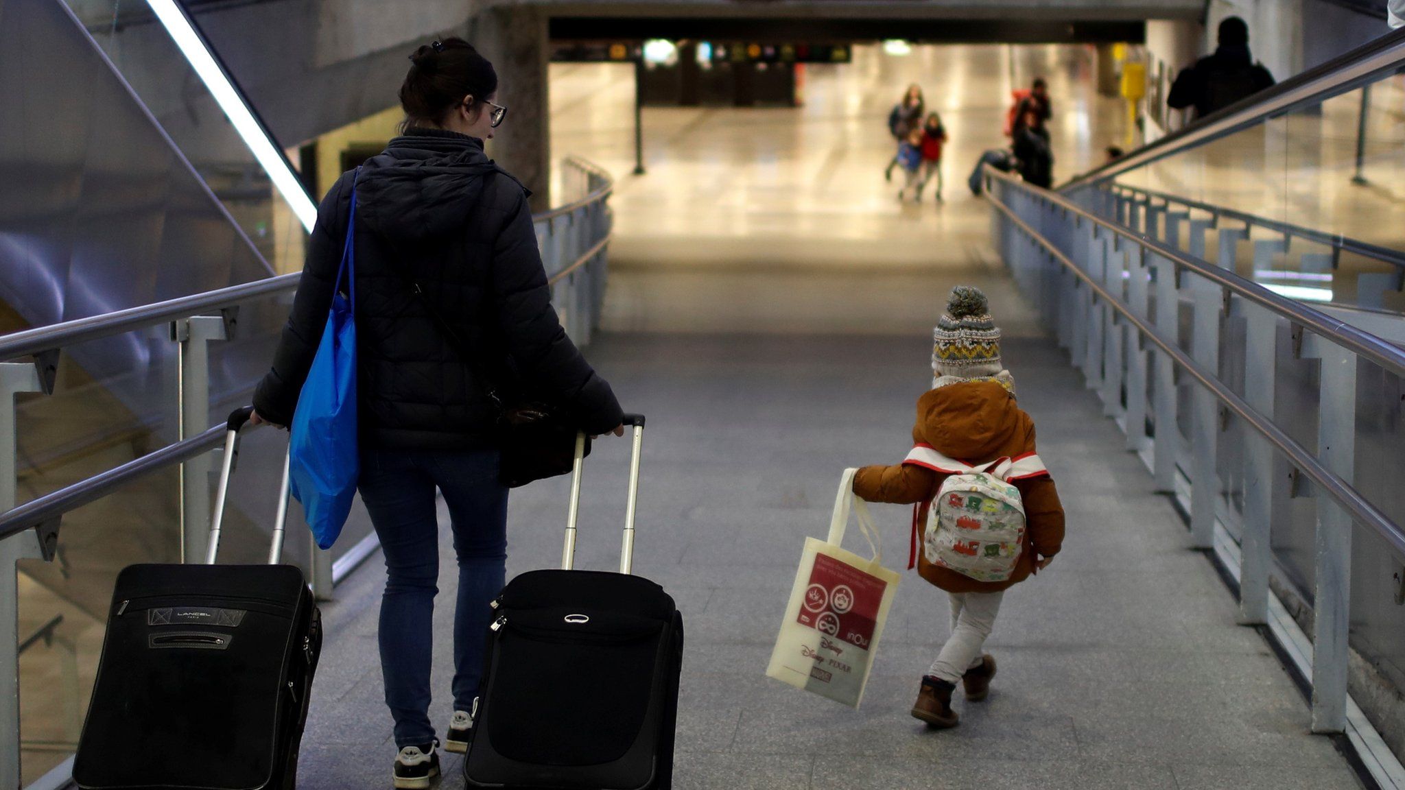 A child using a special train service allowing minors to travel without their parents gets ready to board a train in Paris on 22 December 2019
