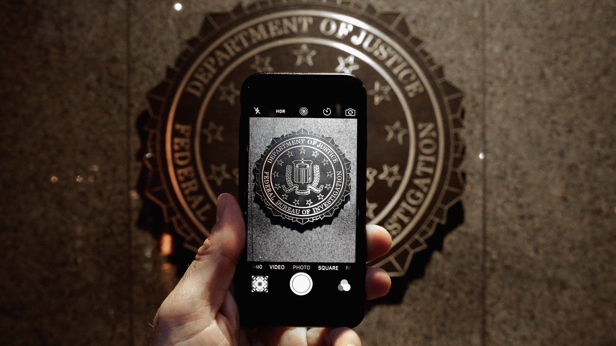 Official seal of the FBI is seen on an iPhone's camera screen on February 23, 2016 in Washington DC