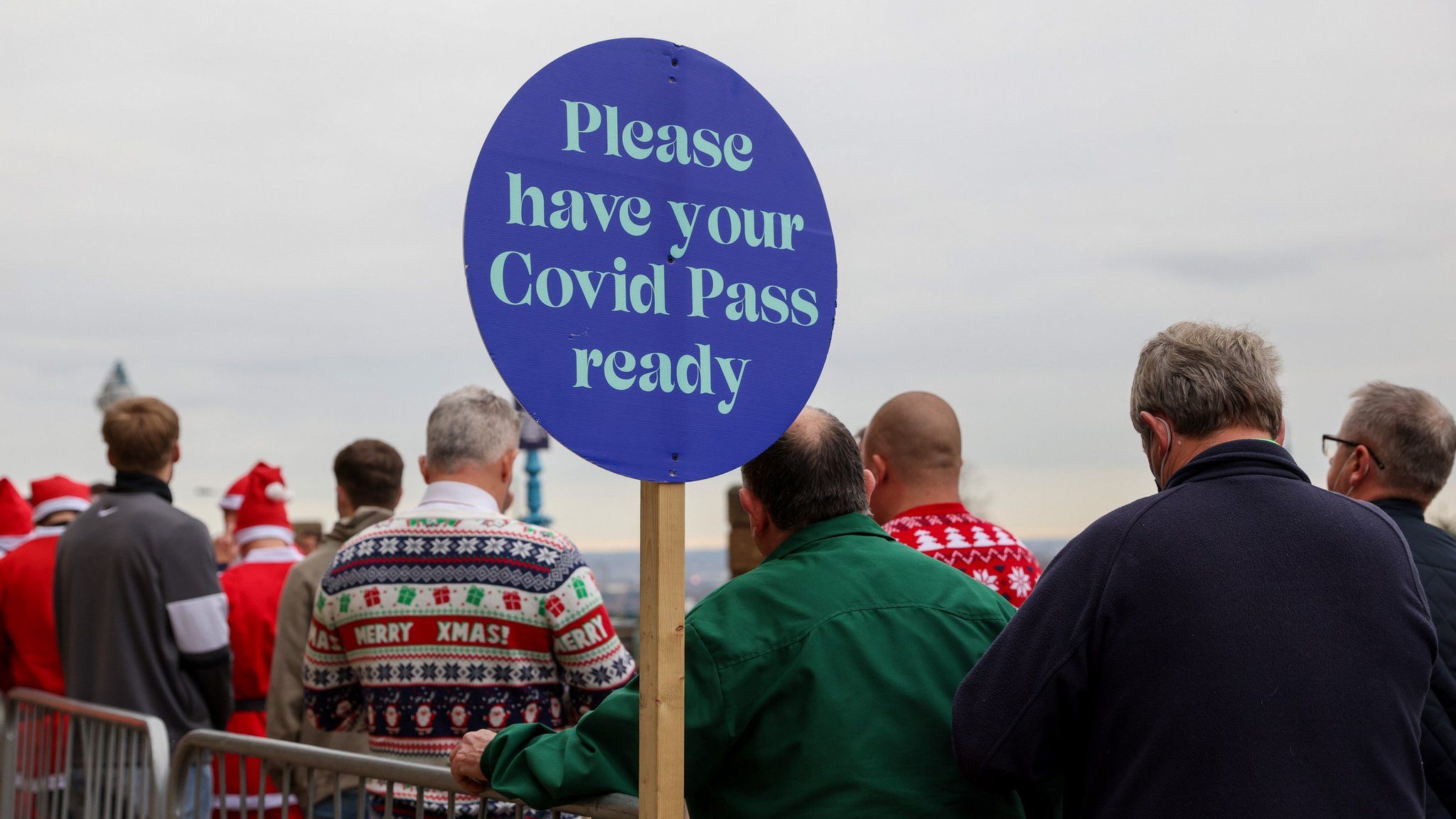 A sign at the darts asking attendees to show their NHS Covid pass