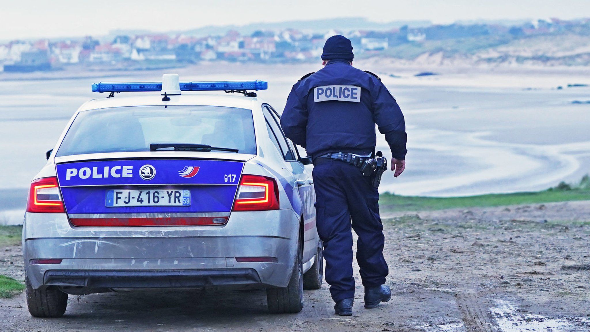 French policeman next to his patrol car