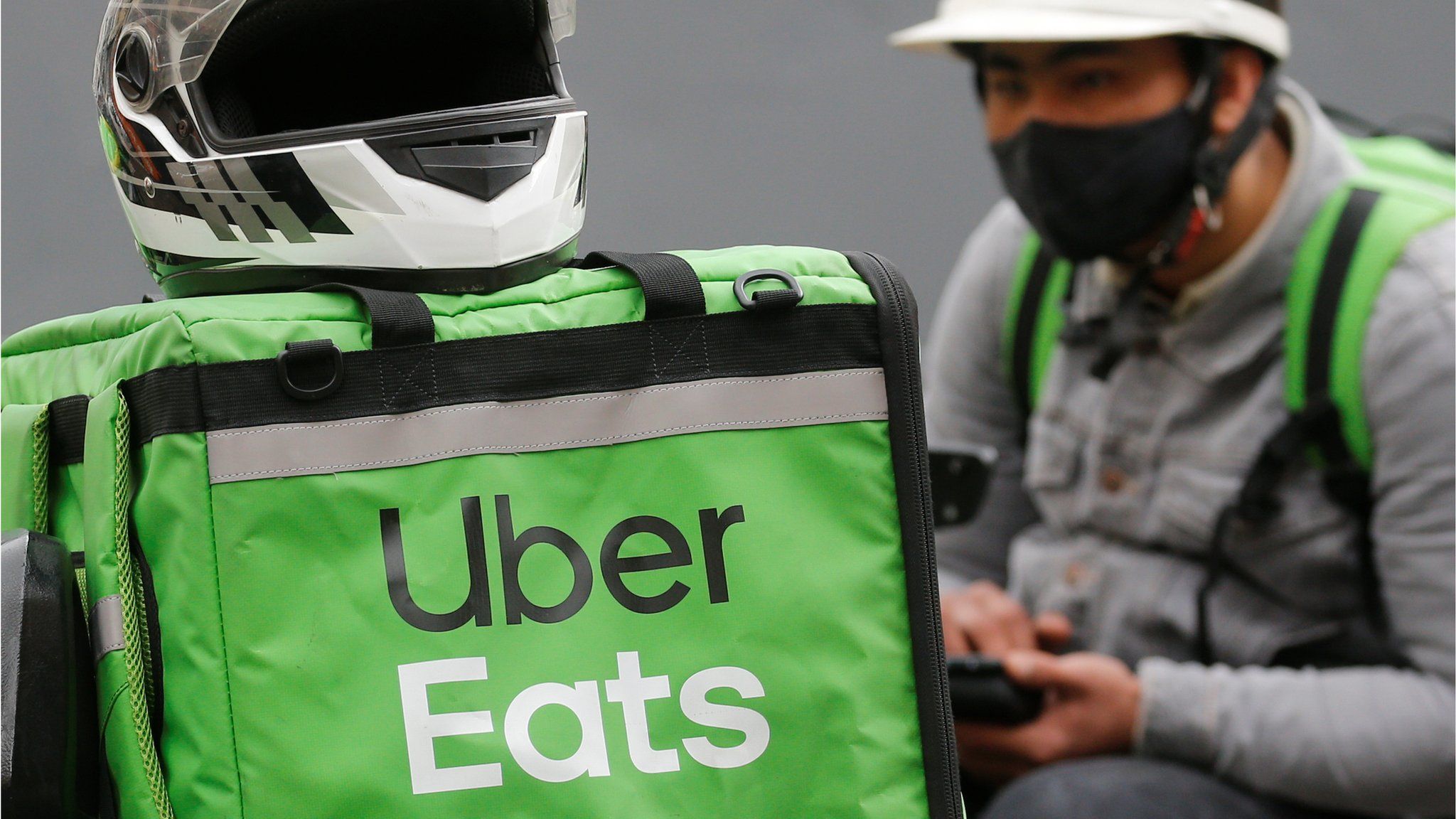 An Uber Eats food delivery courier wearing a protective face mask waits for an order amid the outbreak of the coronavirus disease (COVID-19) in central Kiev, Ukraine May 27, 2020