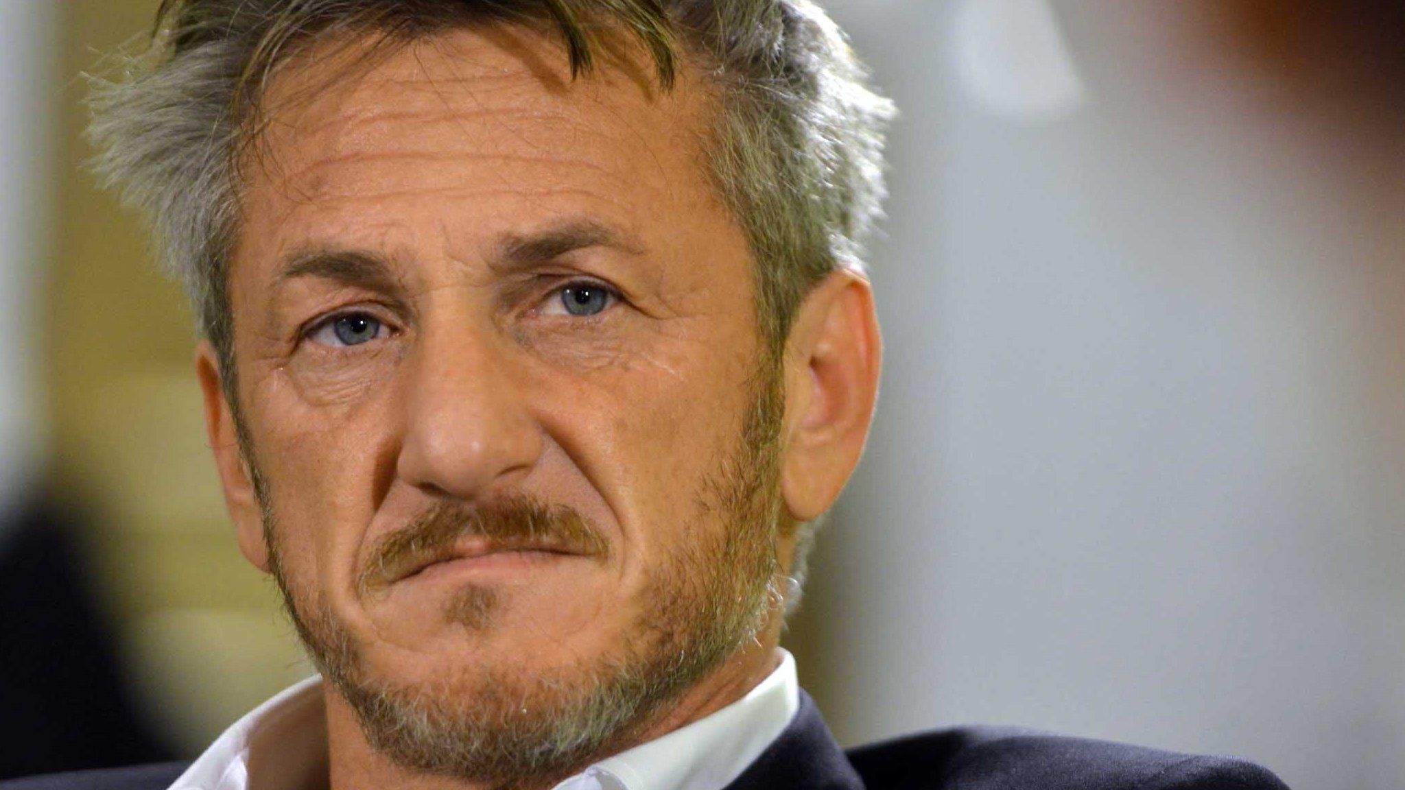 Sean Penn as he looks at someone during a discussion