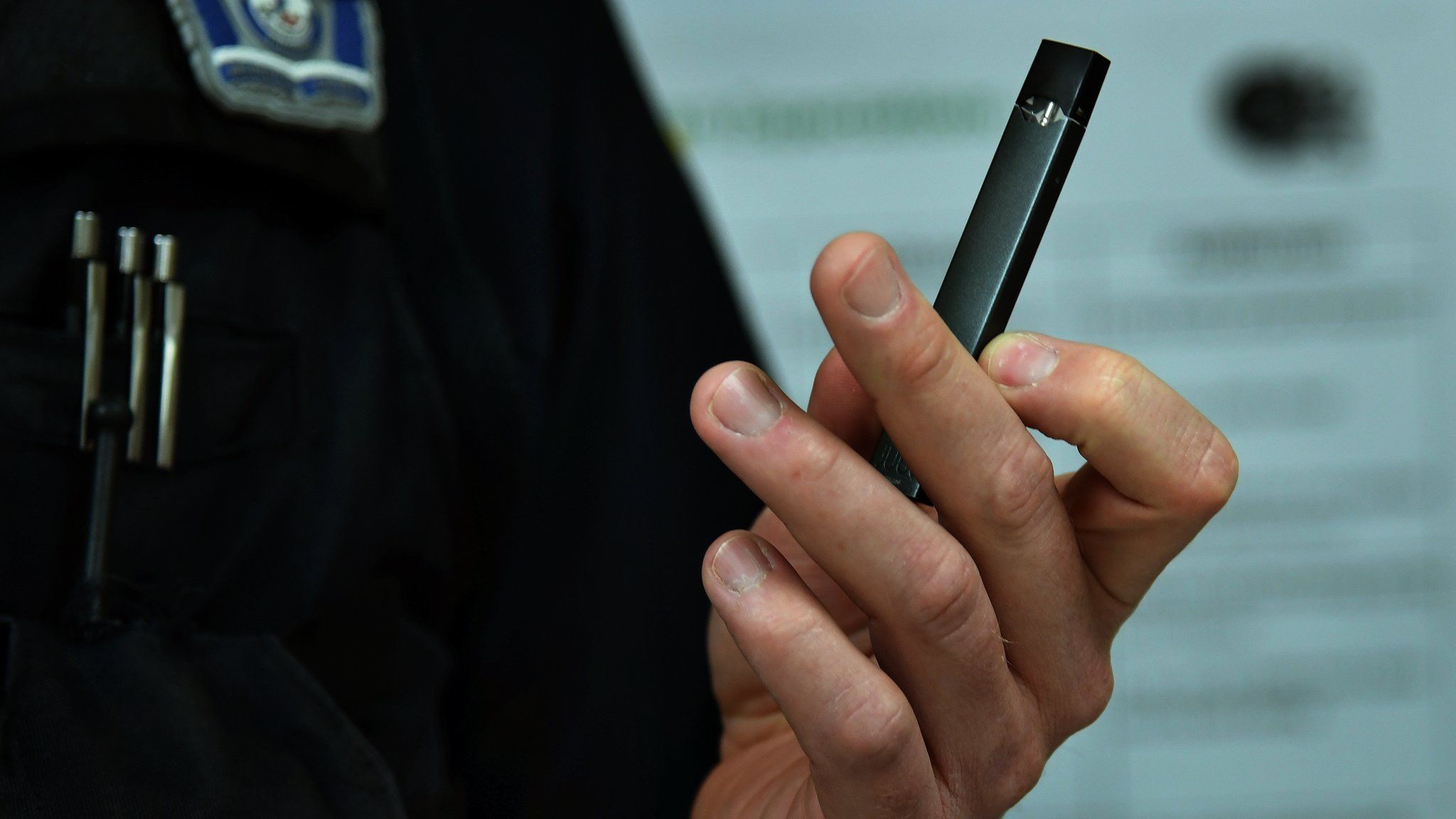 Detective Timothy Koch of the Arlington County police department school resource unit holds a JUUL device that's popular with teens in the area.