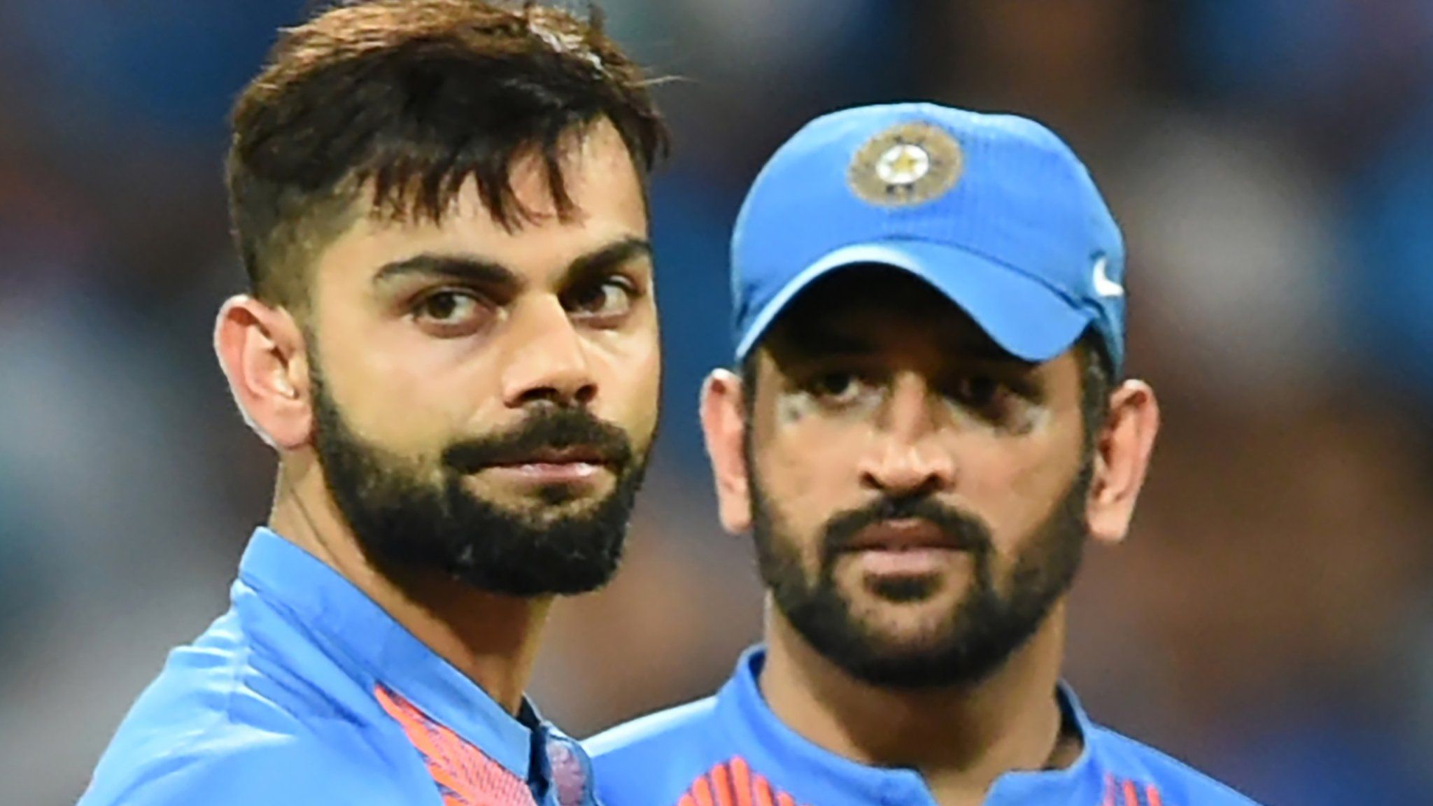 India's Virat Kohli(L)and captain Mahendra Singh Dhoni look on after defeat in the World T20 cricket tournament second semi-final match between India and West Indies at The Wankhede Stadium in Mumbai on March 31, 2016.