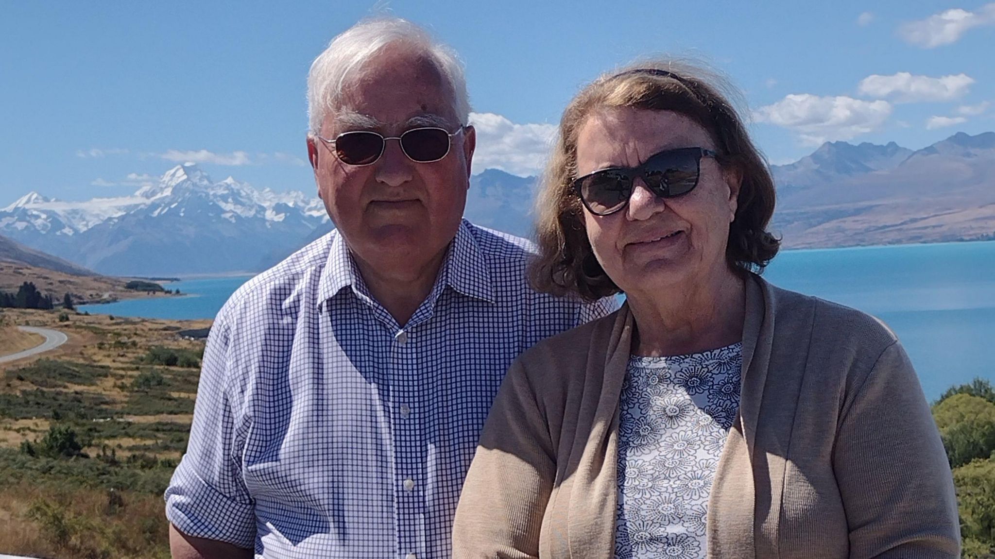 Marten Clarke and Lesley Clarke in New Zealand, both smiling and wearing sunglasses