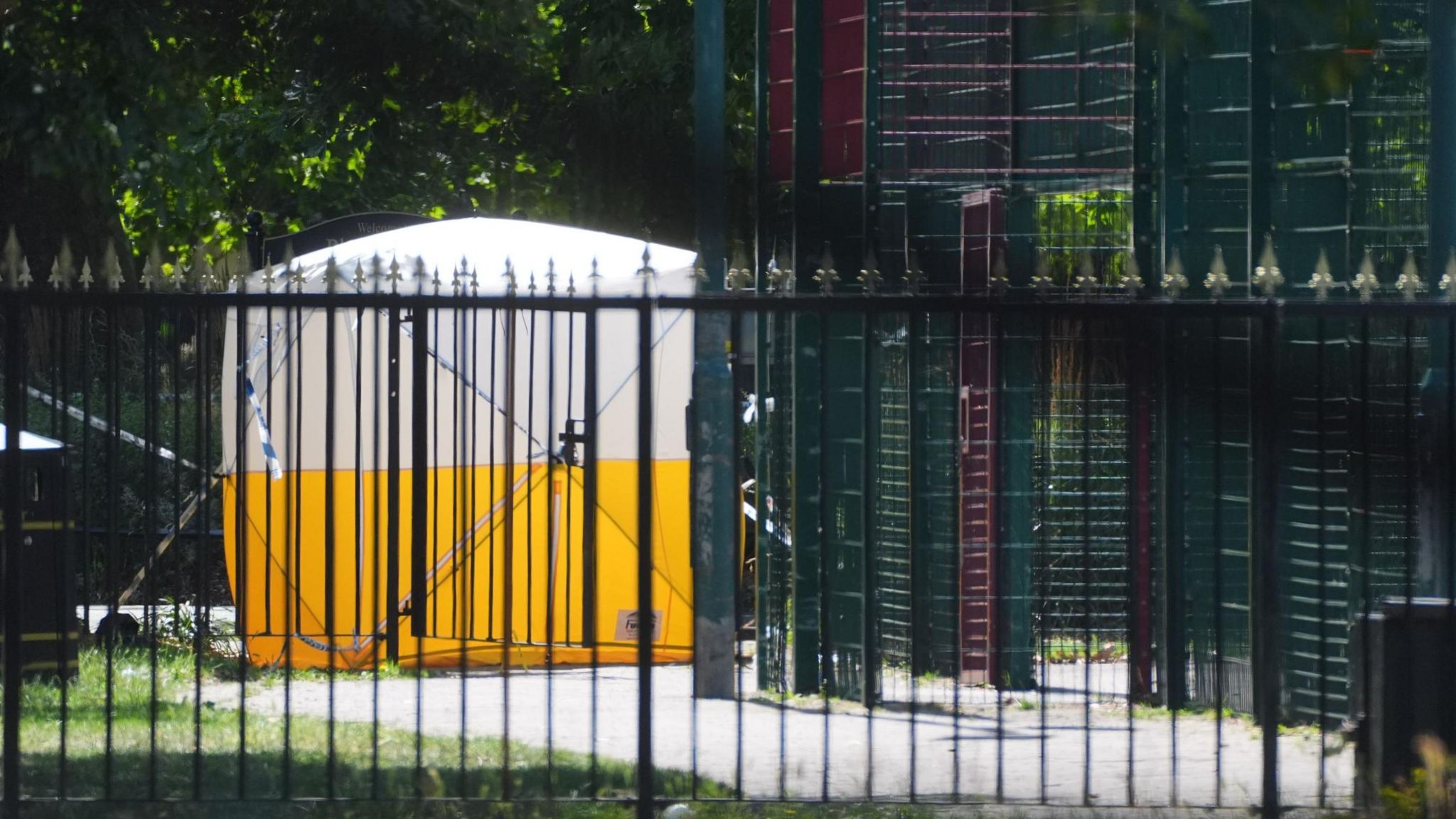 A police tent has been erected beside a basketball court in Plashet Park